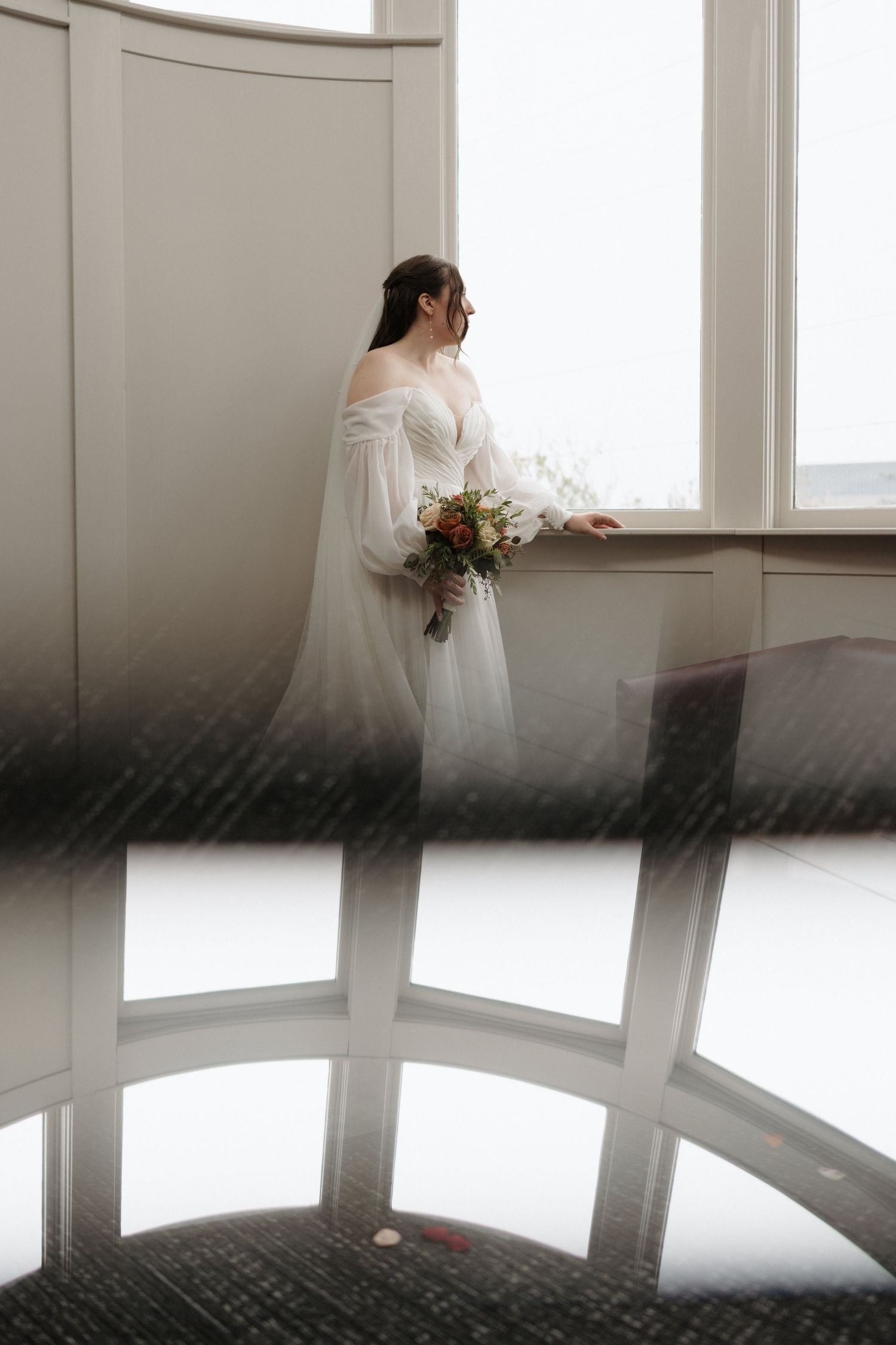 A series of ethereal wedding photos showing a bride in a flowing white dress standing near bright windows.