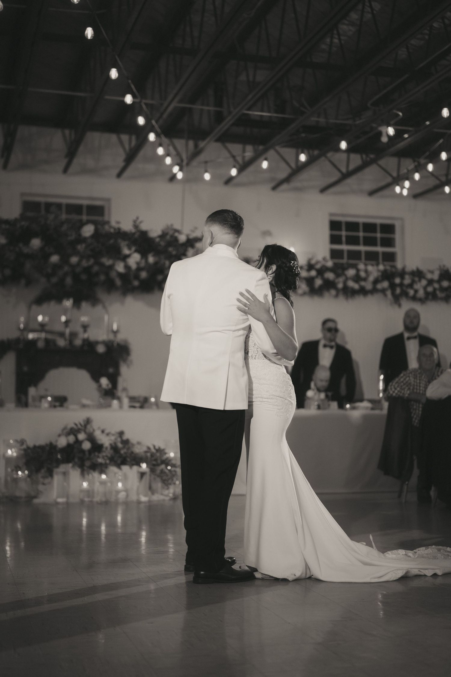 A romantic black and white photo sequence of a couple's first dance at their wedding reception.
