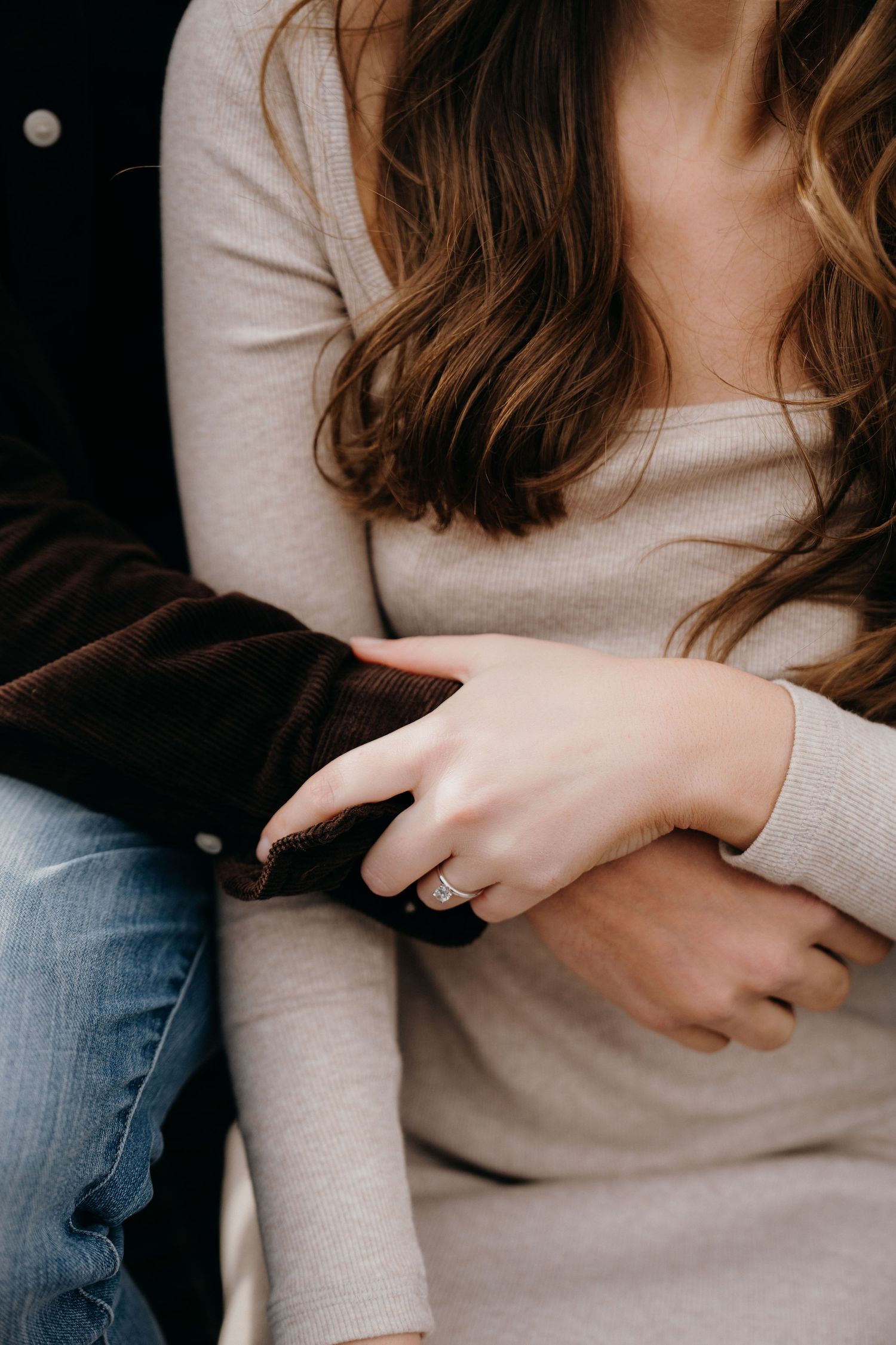 Detail shots focusing on hands and casual clothing during intimate moment.