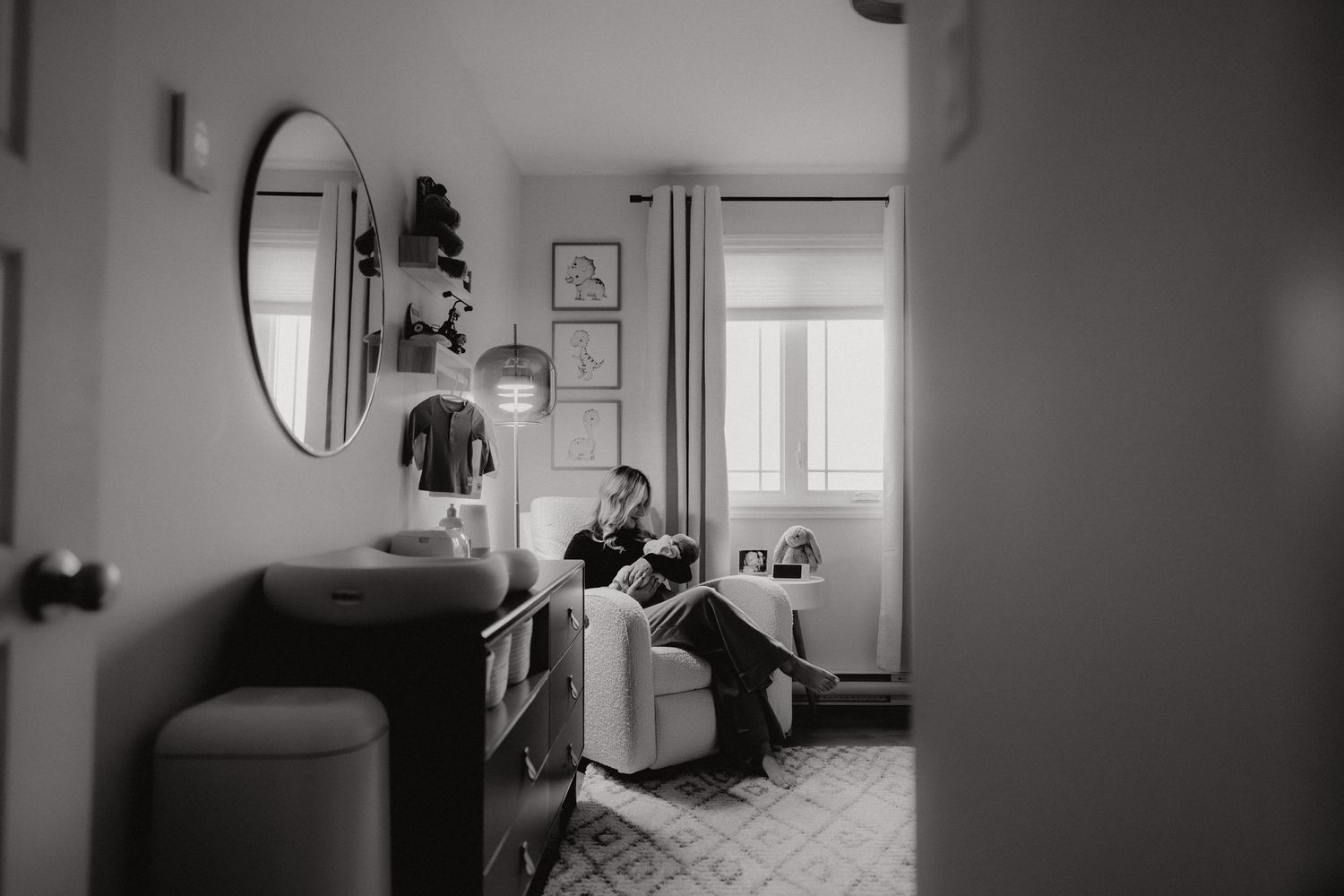 Monochromatic view of an elegantly furnished room with natural lighting.