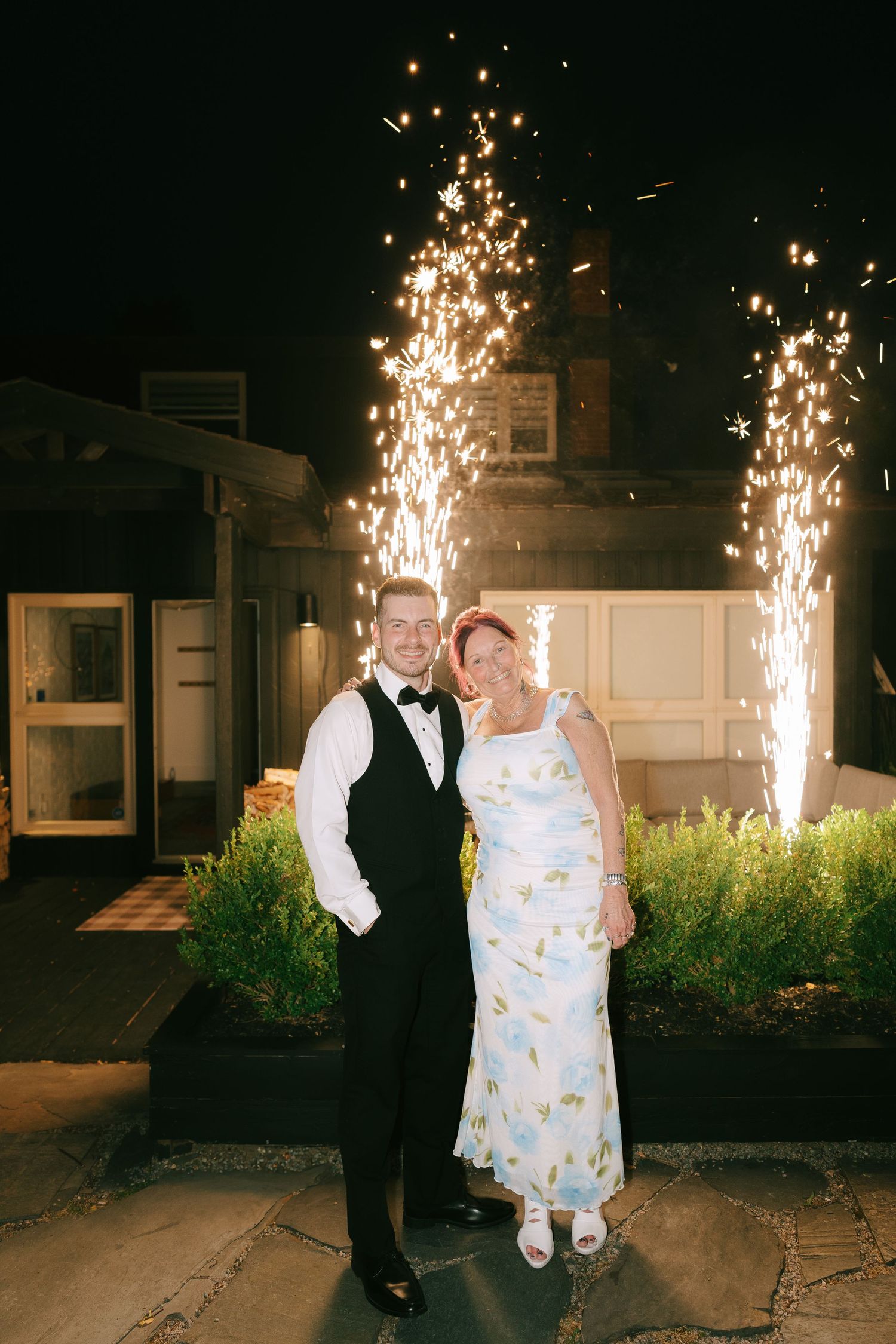 Sparklers create magical backdrop for couple's nighttime wedding celebration.