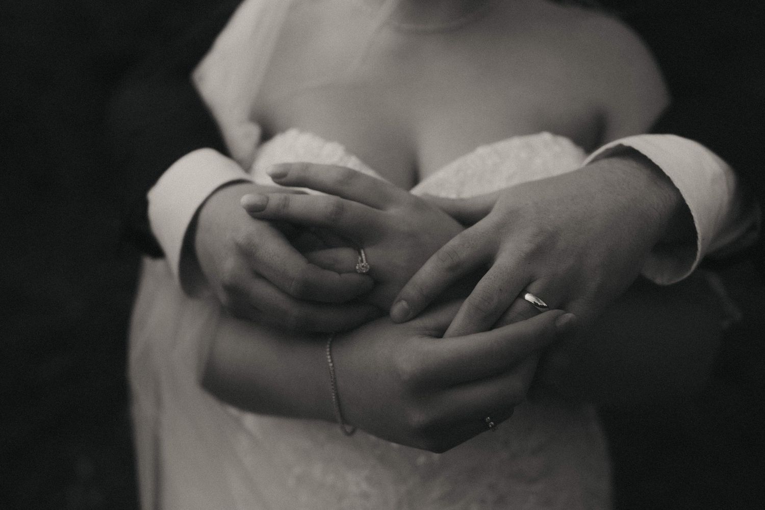 A black and white photo series showing hands gently holding and caressing each other in different poses.