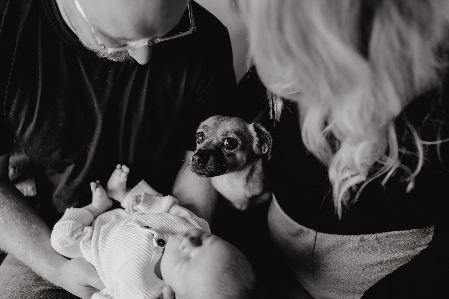 Candid lifestyle photography showing emotional family connection in home setting.