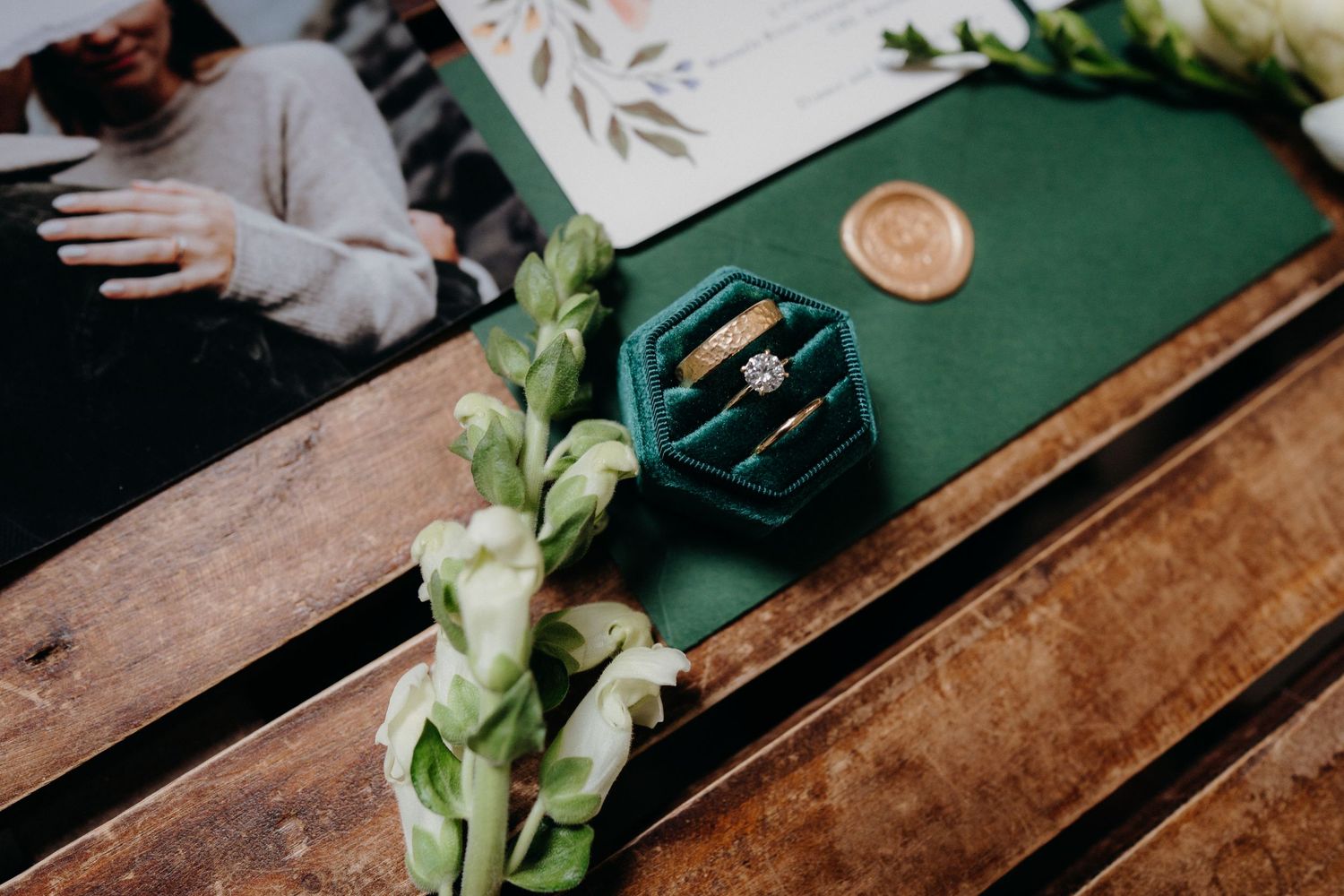 Wedding details featuring elegant floral arrangements and wedding stationery in muted tones.