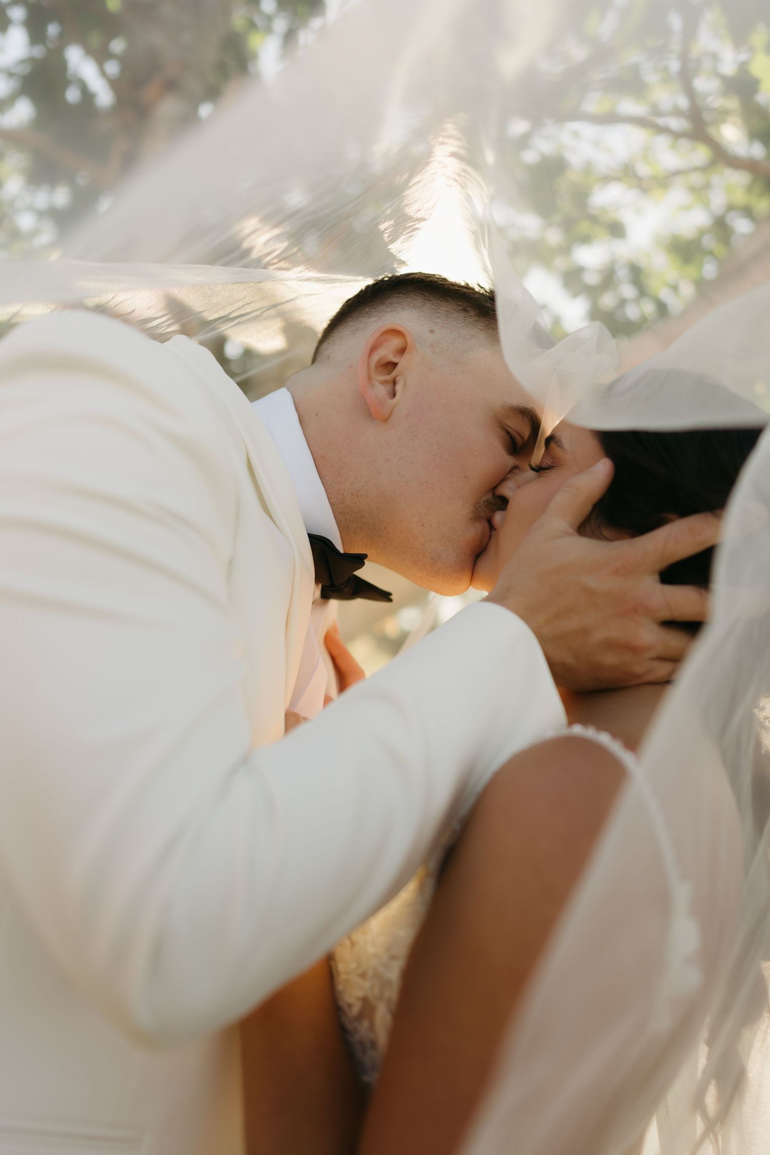 A romantic sequence of wedding photos showing a couple sharing a tender kiss under soft lighting.