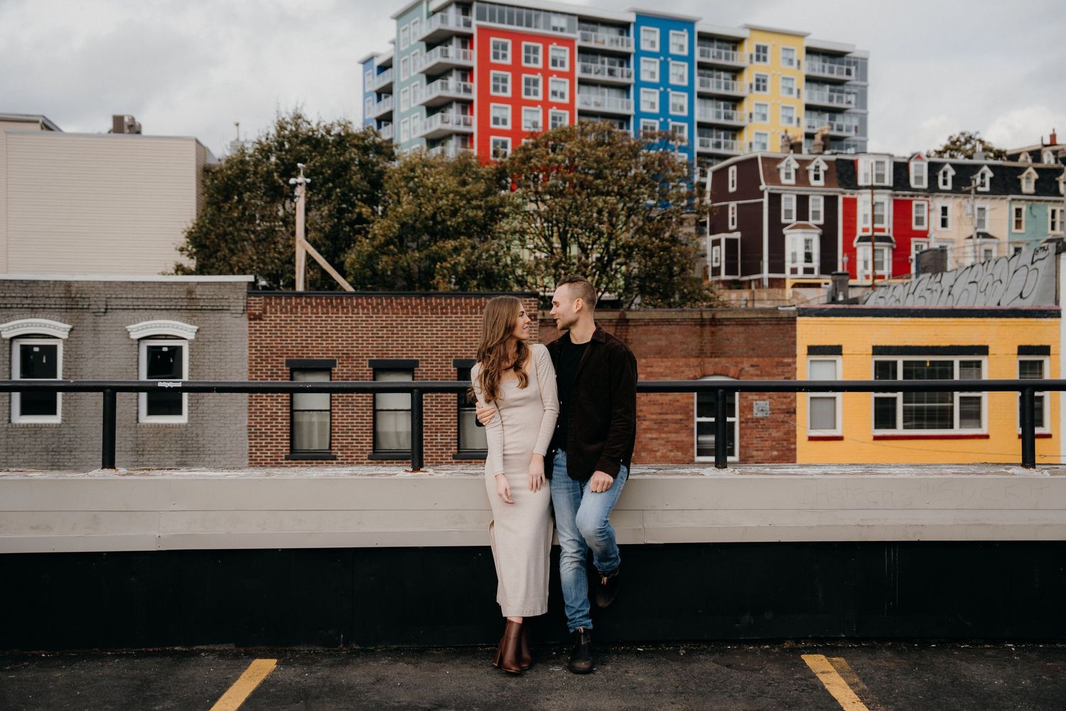 Rooftop photoshoot featuring modern apartment buildings with red, blue and yellow facades.