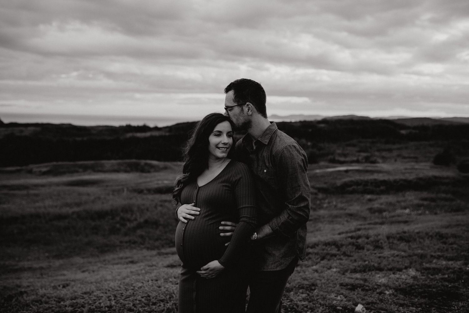 Dramatic black and white landscape photos showing couple's silhouettes against moody sky.