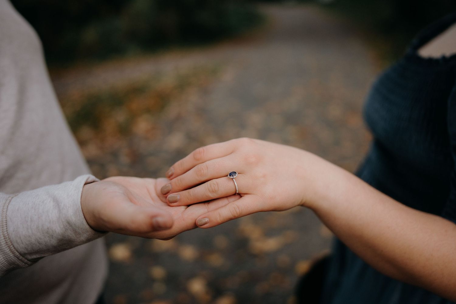 Close up of hands touching in an intimate moment during engagement photos.