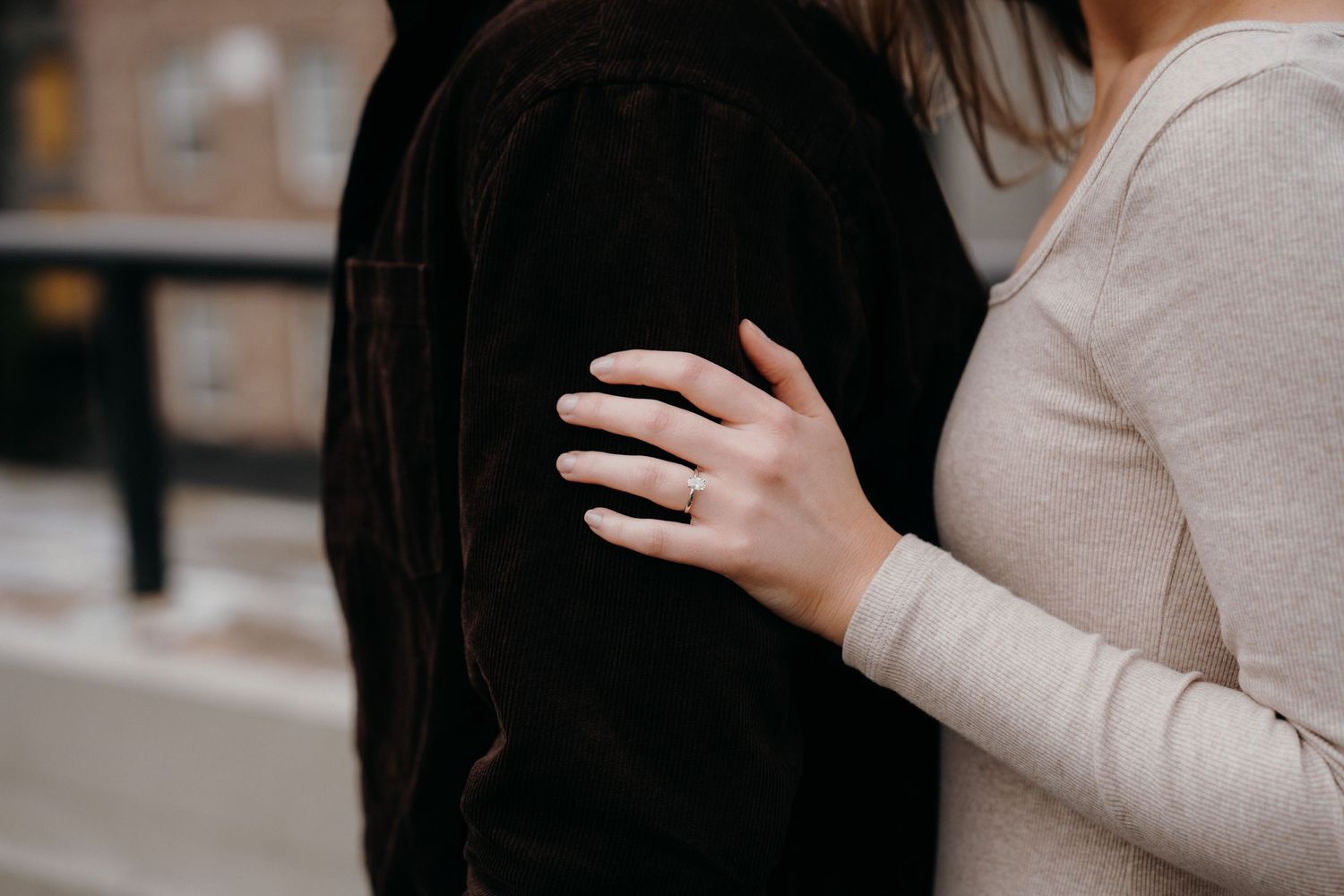An intimate rooftop moment against an urban backdrop with modern buildings.