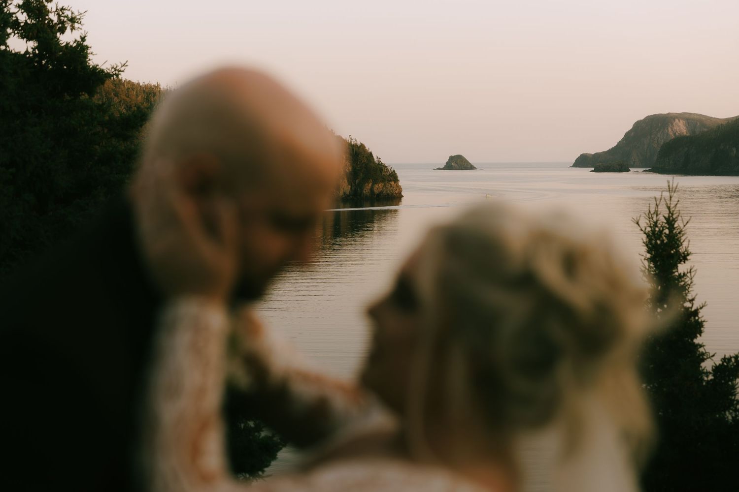 Rocky coastline and ocean views create a dreamy backdrop for a wedding photoshoot.