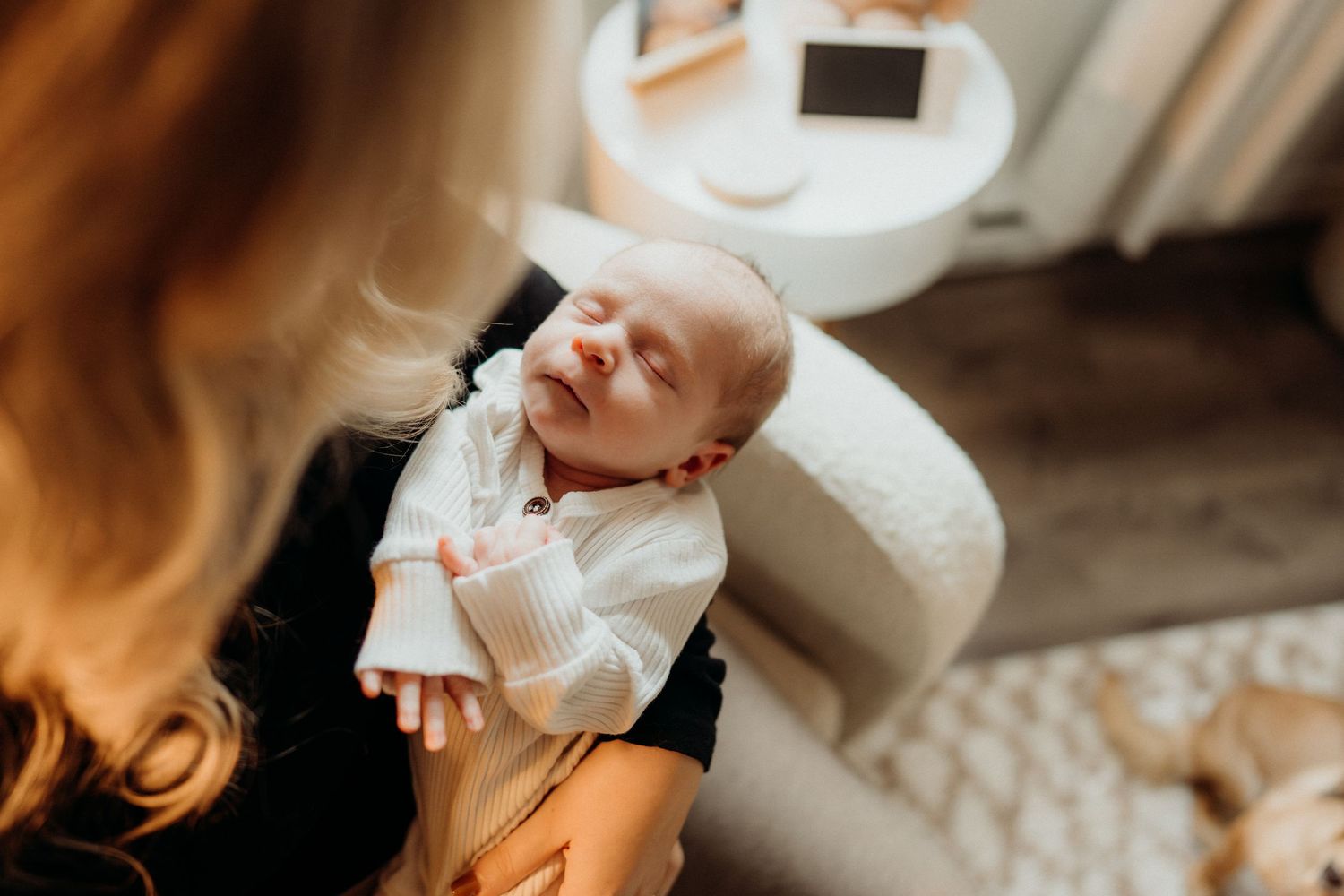 Baby nursery with soft textural elements and warm lighting creating peaceful ambiance.
