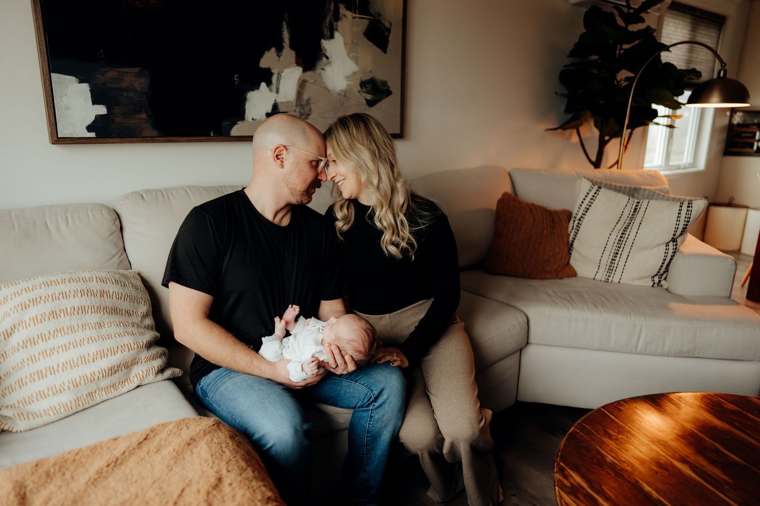 Lifestyle photograph capturing tender family moments in a warmly lit living room interior.