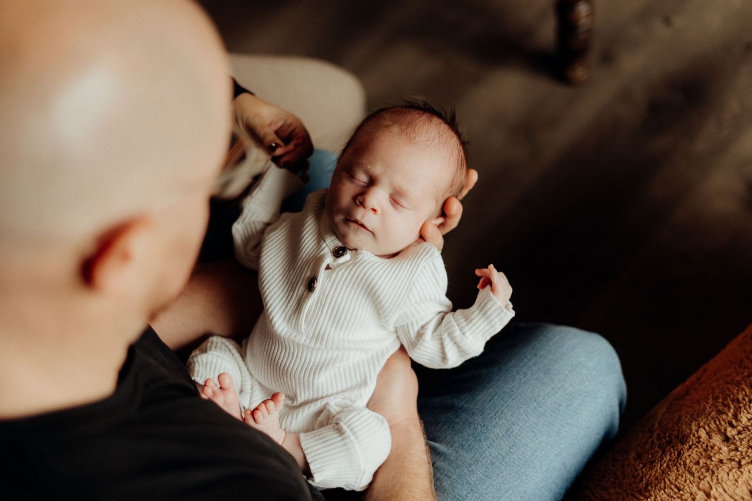 Candid family lifestyle moment captured in a modern living room with natural lighting.