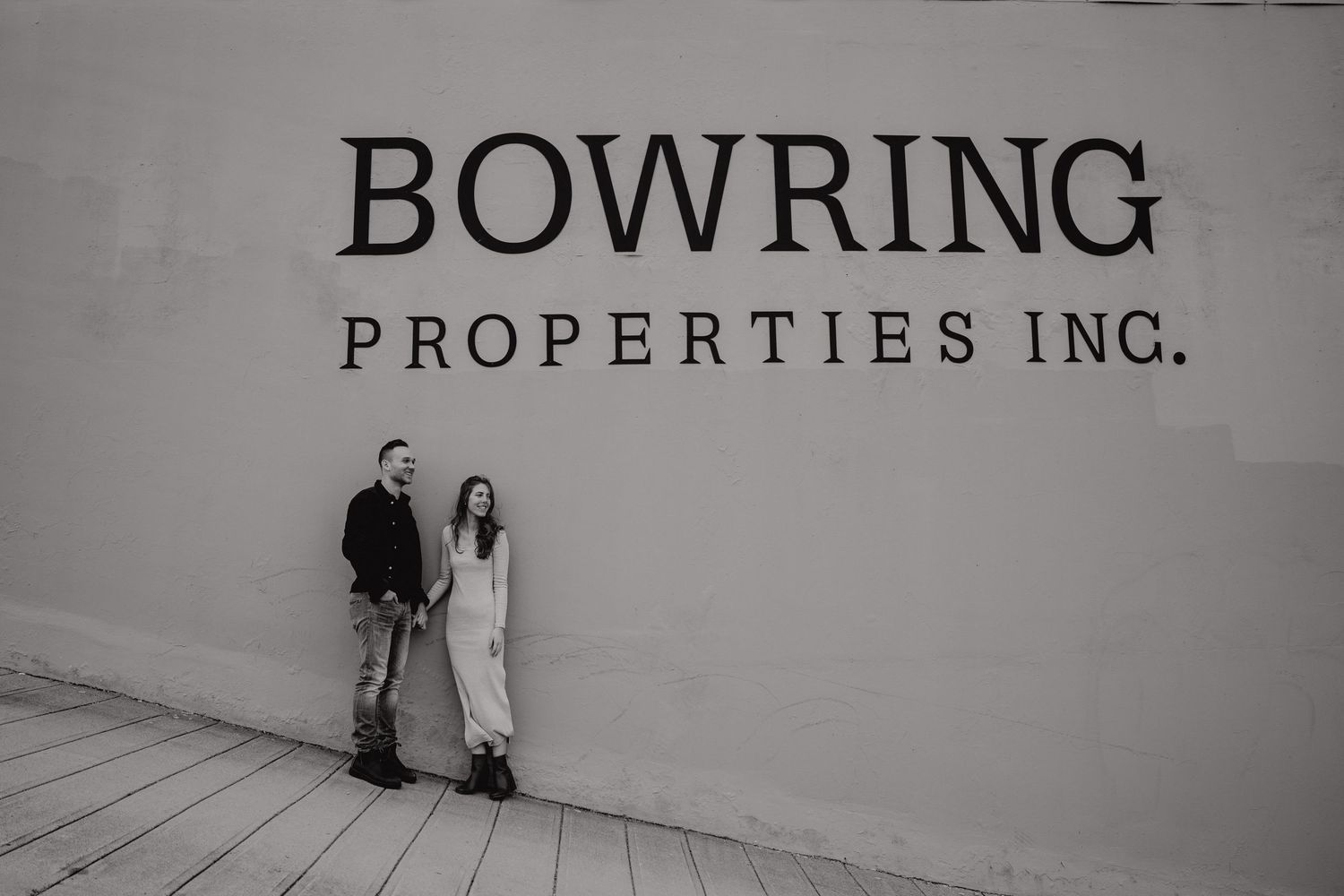 Black and white signage for Bowring Properties Inc on a wall.