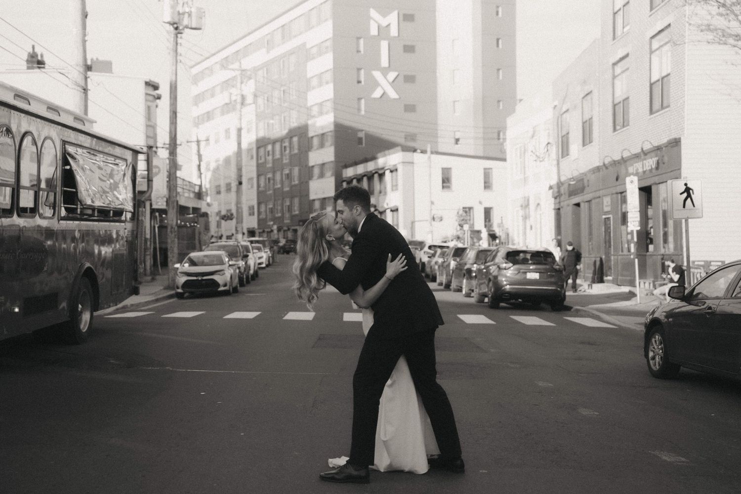 Urban street scene with couple dancing in black and white photography.