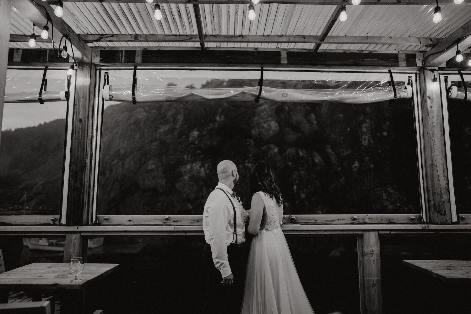 A black and white photo collage showing multiple wedding scenes with couples and guests at an outdoor venue.