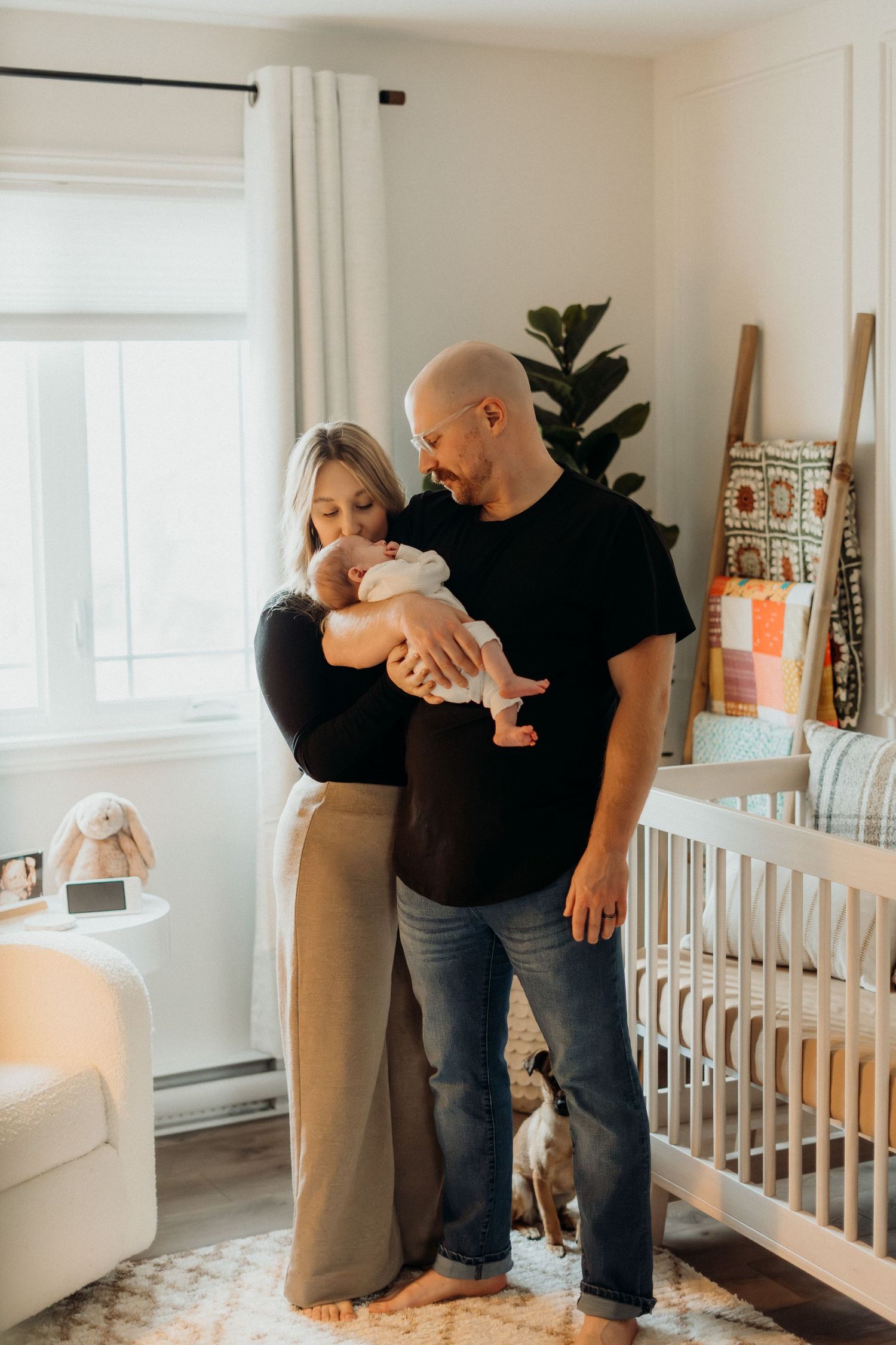 Joyful interaction between adult and baby in bright, contemporary nursery setting.