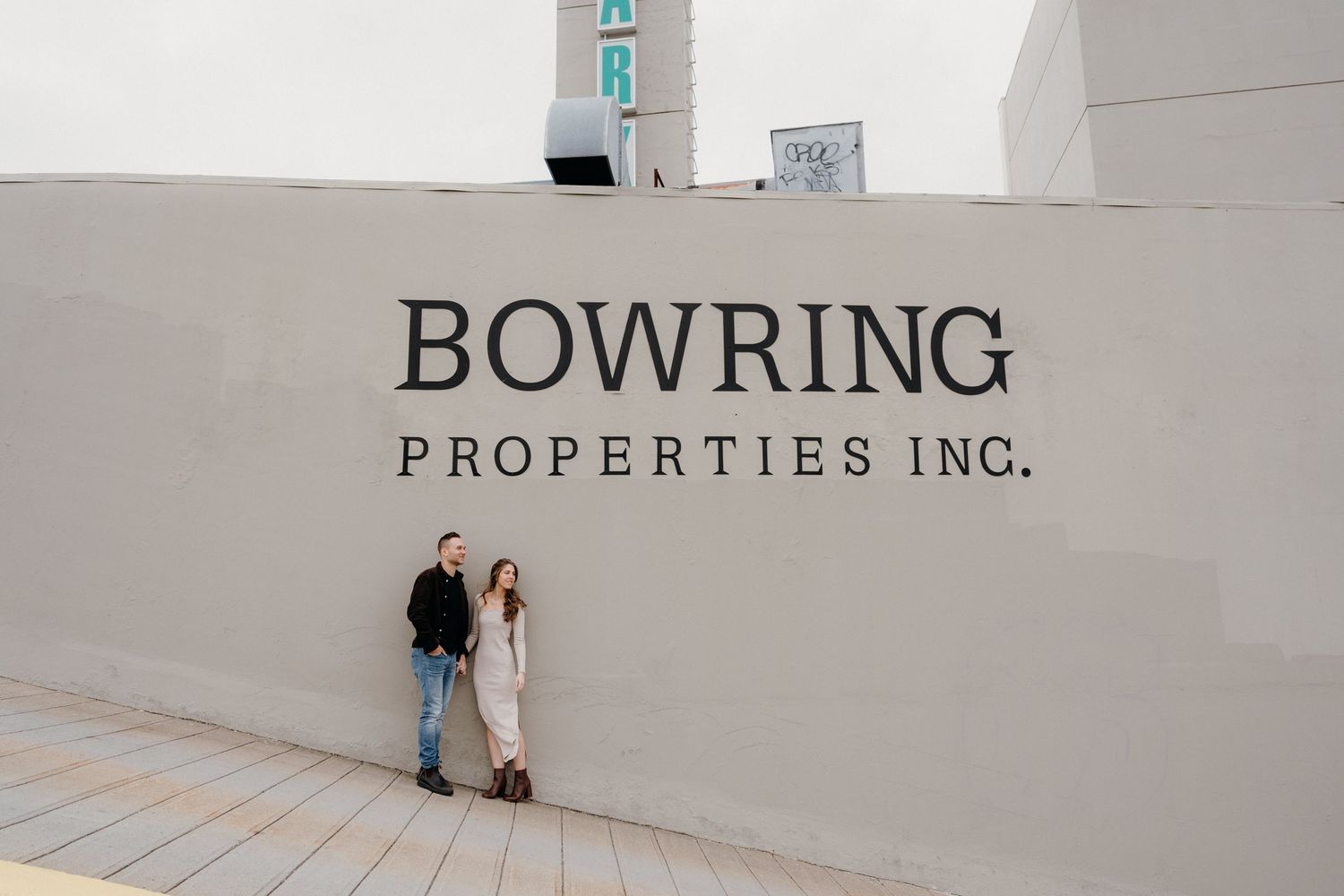 Clean corporate branding signage for Bowring Properties Inc on white wall.