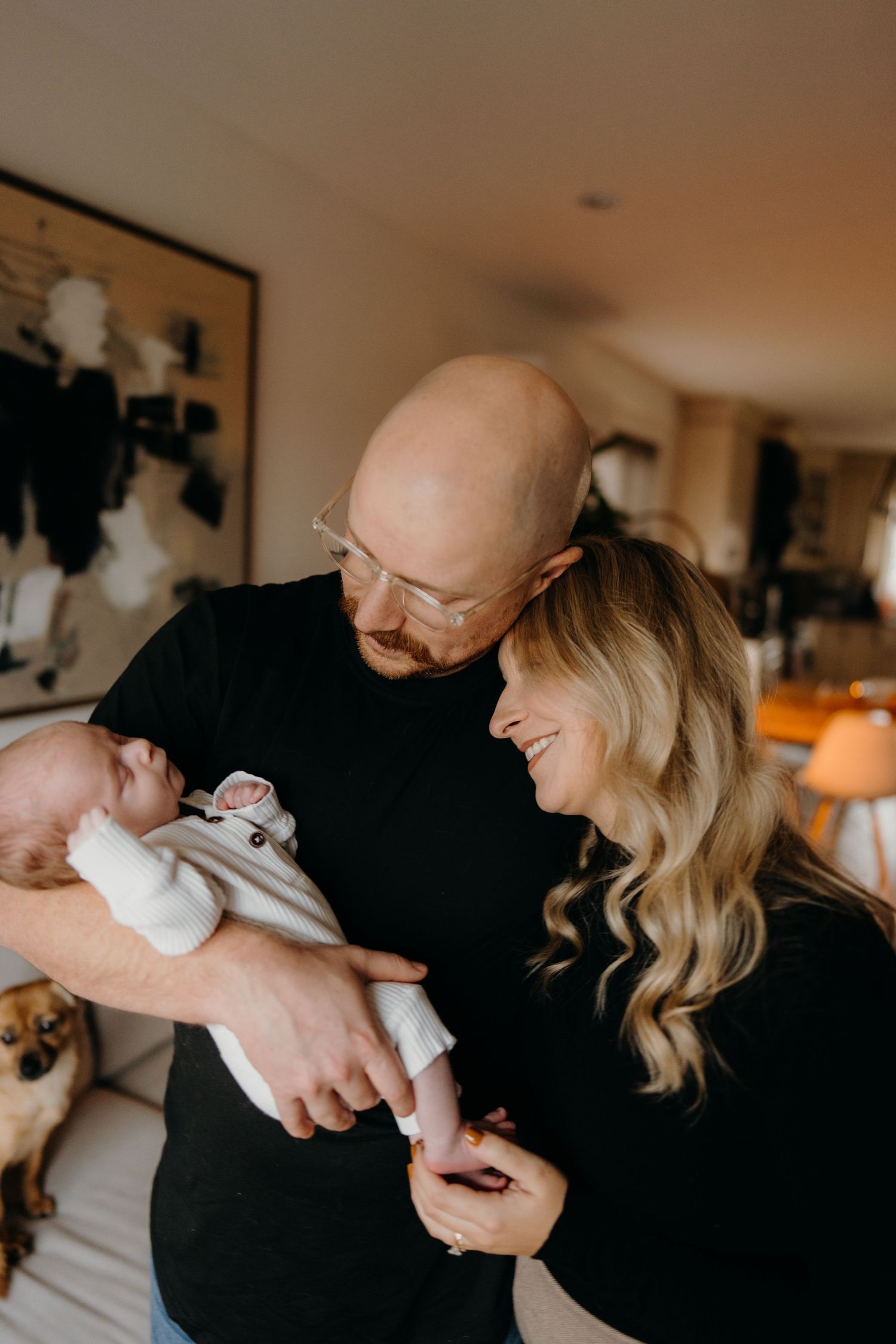 Candid lifestyle photo of parents enjoying tender moments with their newborn.