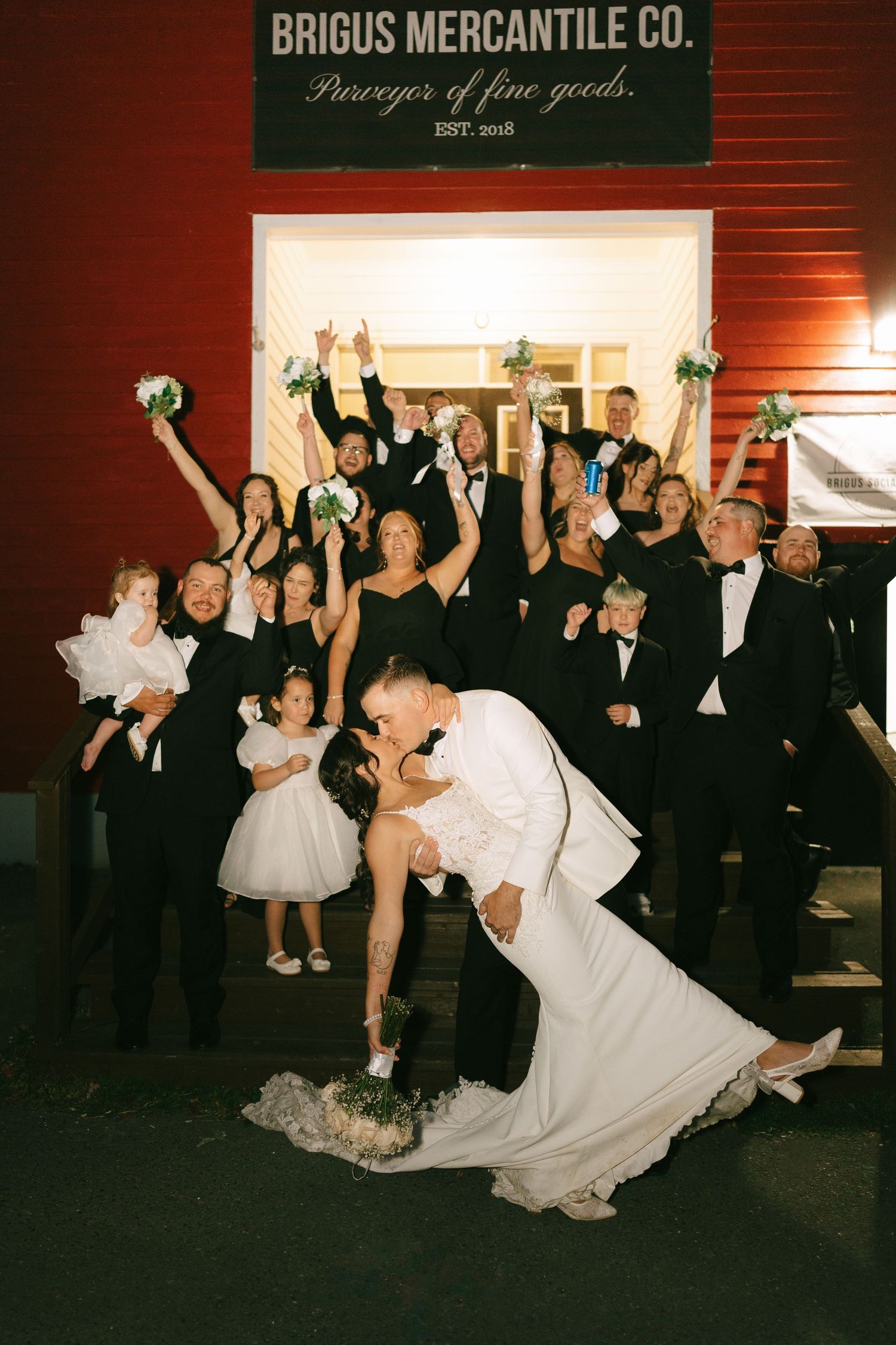 Wedding party dancing and celebrating during reception at Brigus Mercantile Co with guests in formal attire.