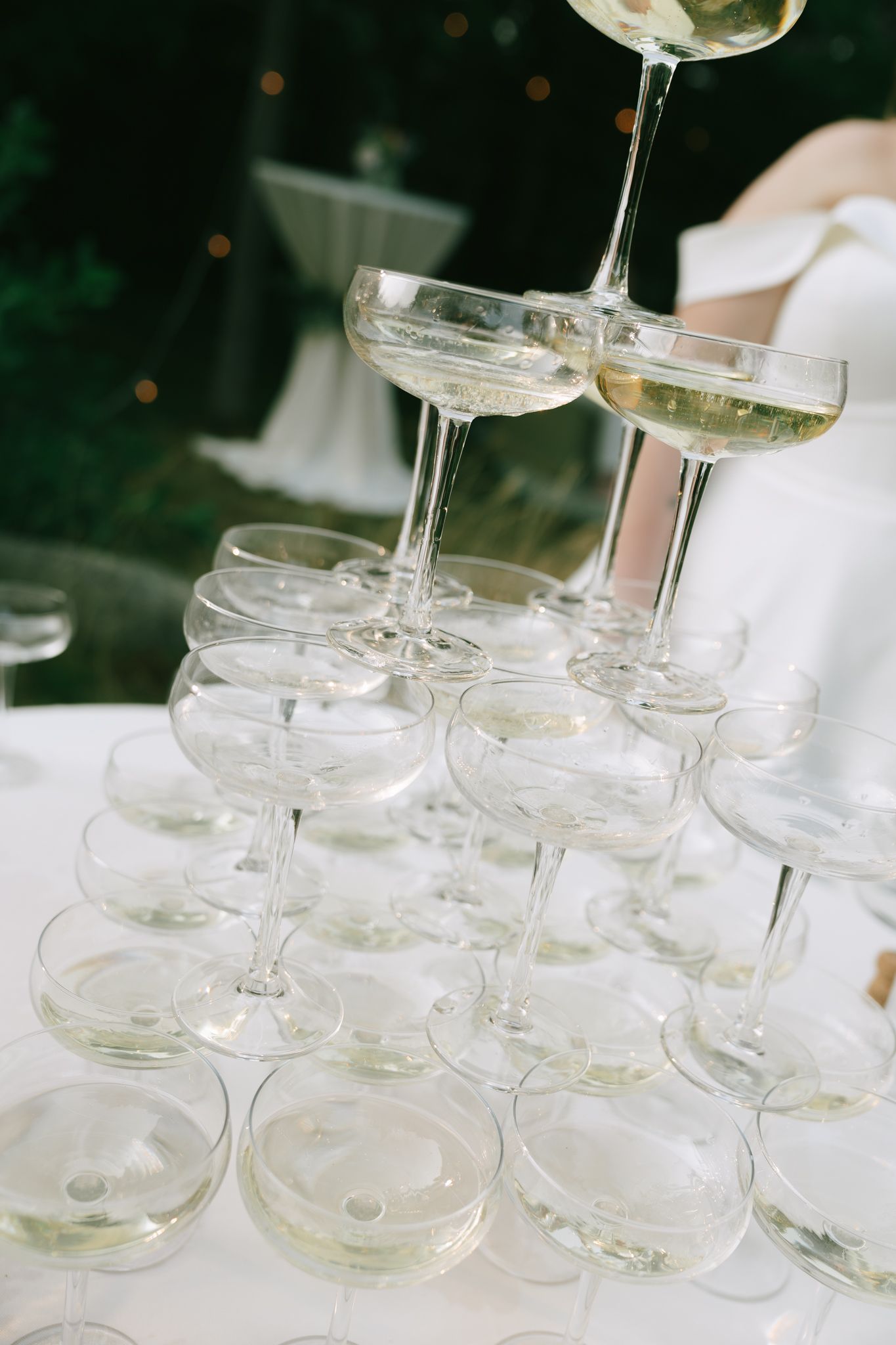 Close-up of stacked champagne coupe glasses ready for a celebratory pour.