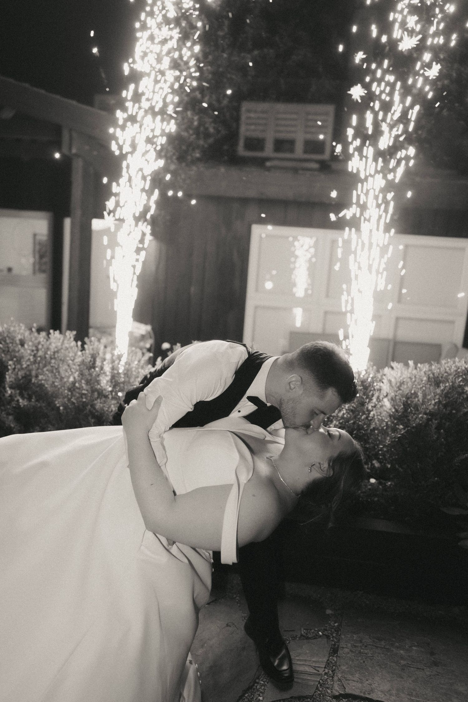 A romantic dip during a nighttime dance with sparklers illuminating the background.