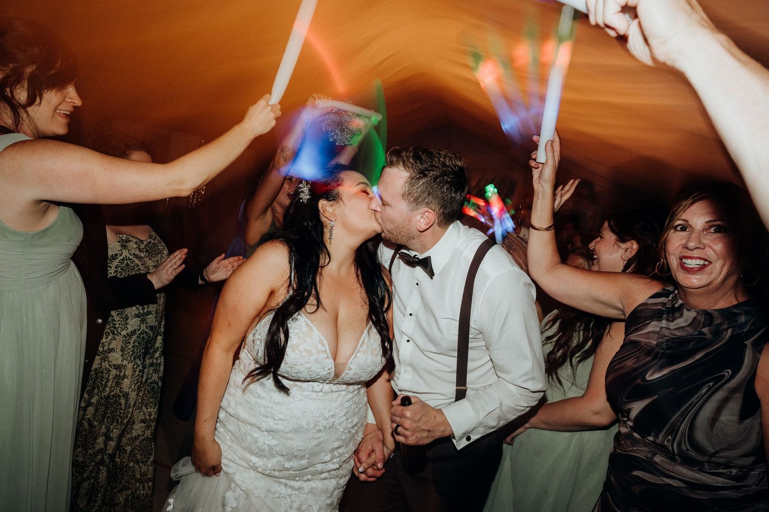 Lively dance floor scene with party lights at wedding reception.