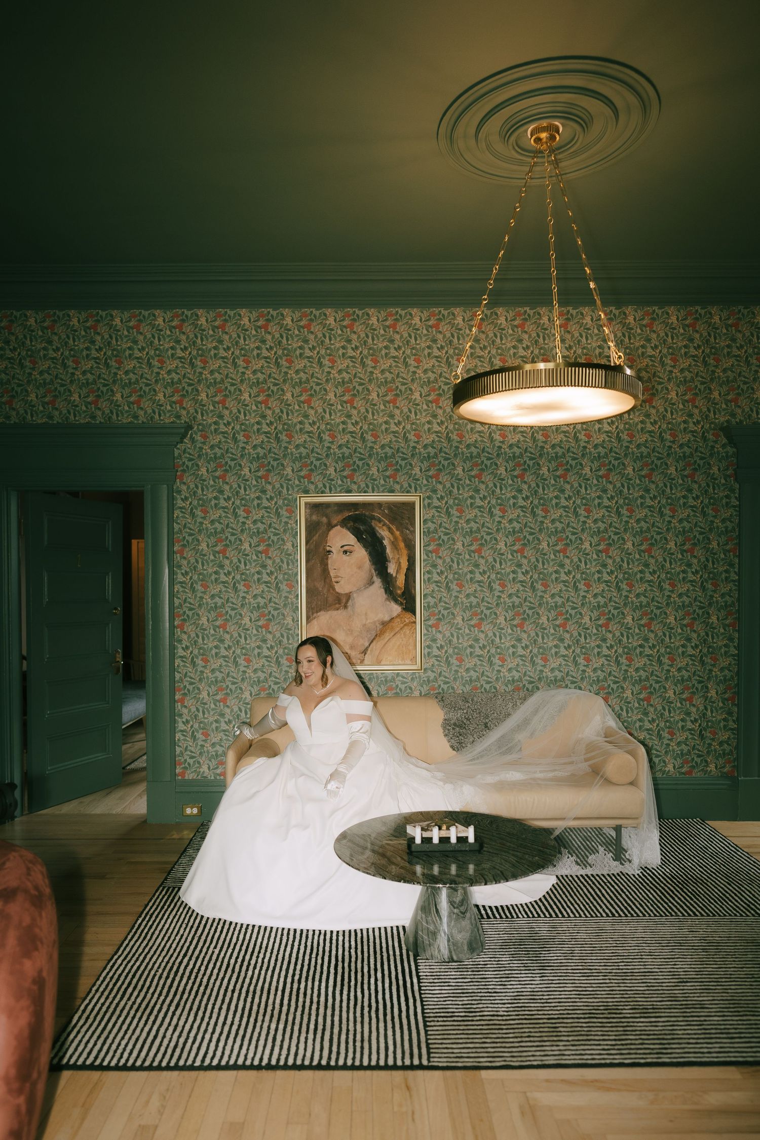 Artistic sequence of bride posing on bed against green floral wallpaper.