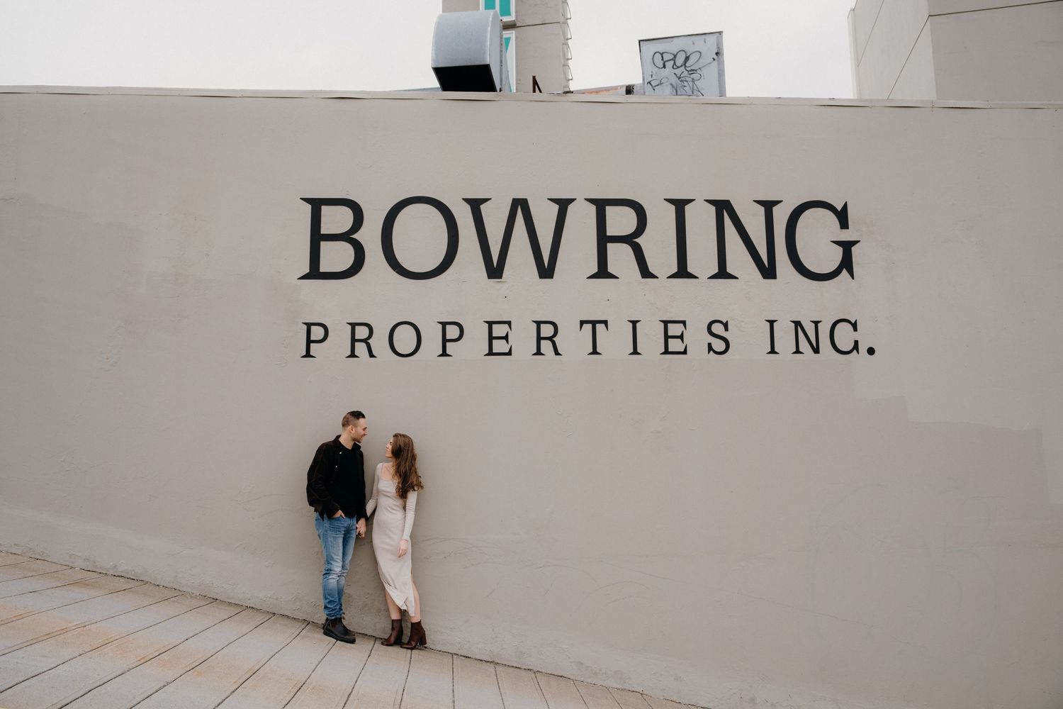 Corporate signage for Bowring Properties Inc mounted on a minimalist white wall.