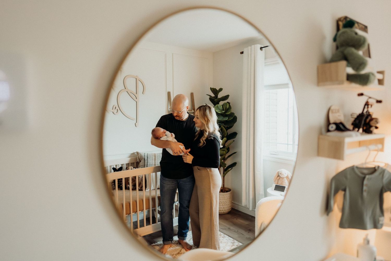 Multiple mirror reflections capture intimate moments in a light-filled nursery space.