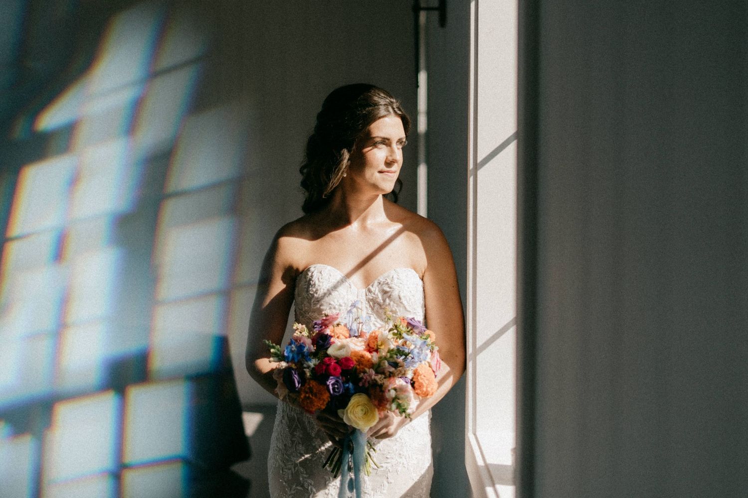 Rustic wedding photography portraits showing couple in window light with romantic composition.
