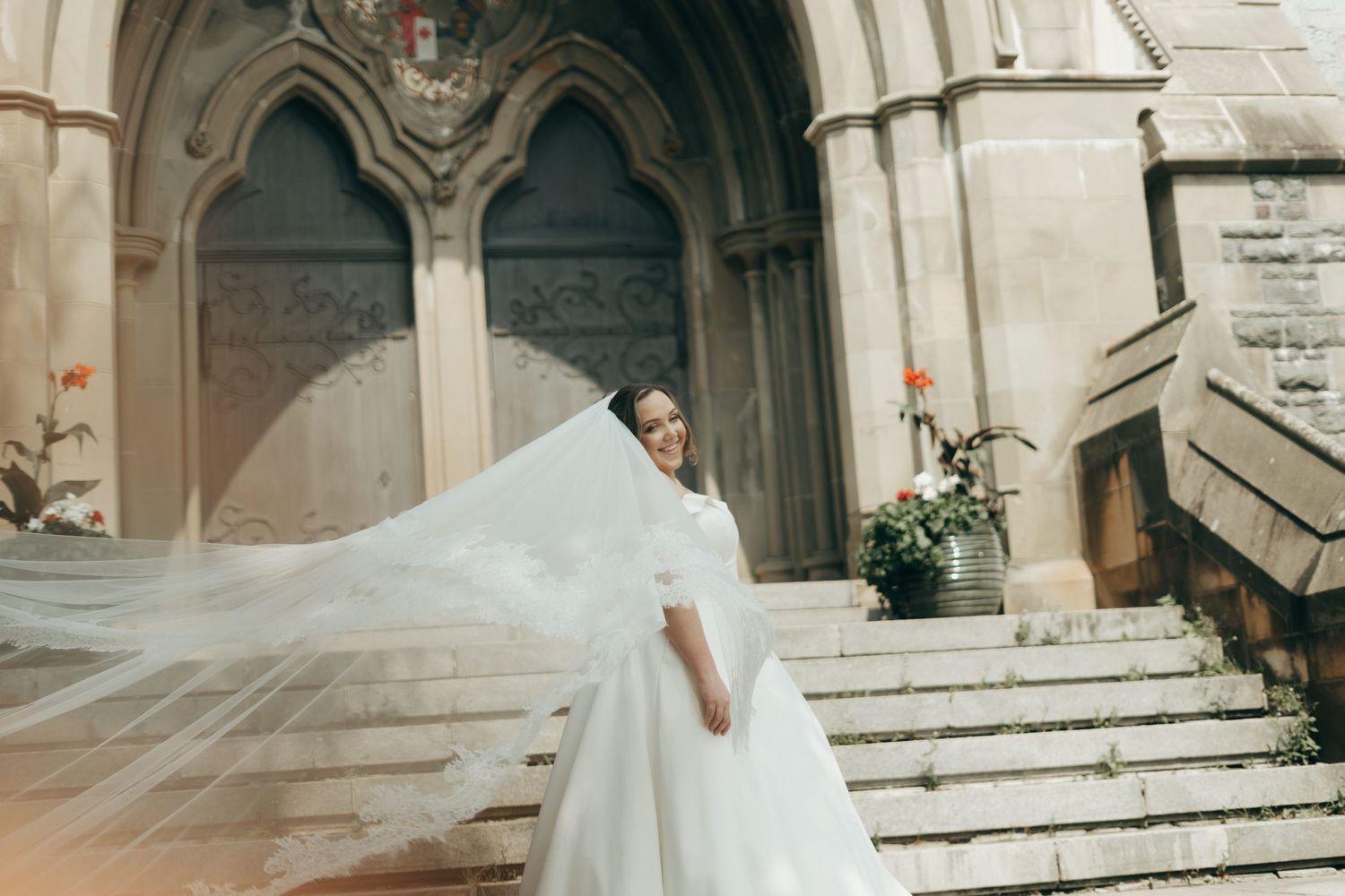 Ethereal wedding dress movement captured against church architecture.