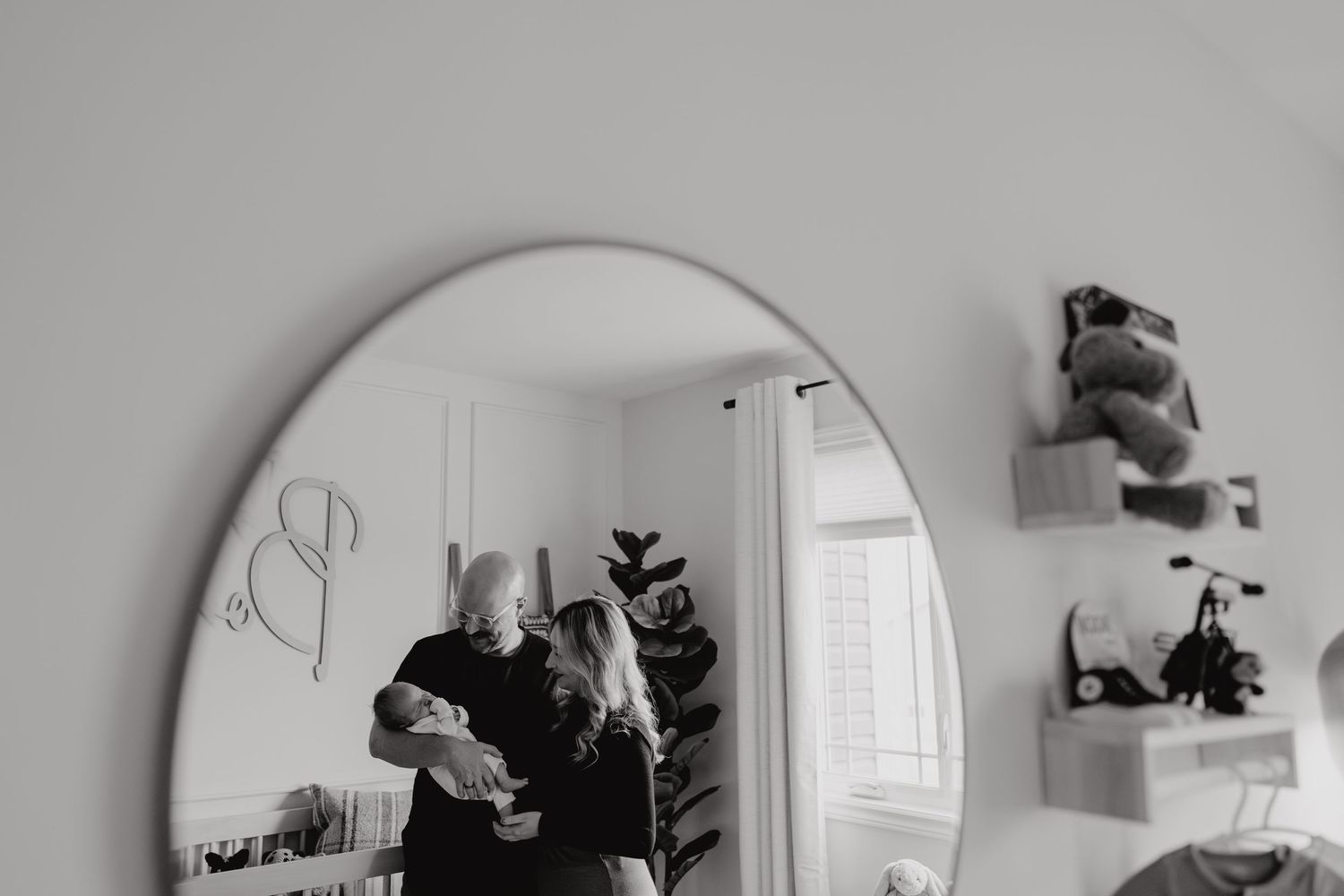 Black and white mirror images showing a series of nurturing moments in a baby's room.