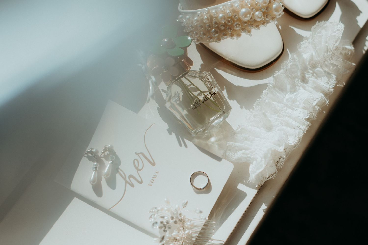 Wedding rings and delicate details captured in soft, dreamy lighting.