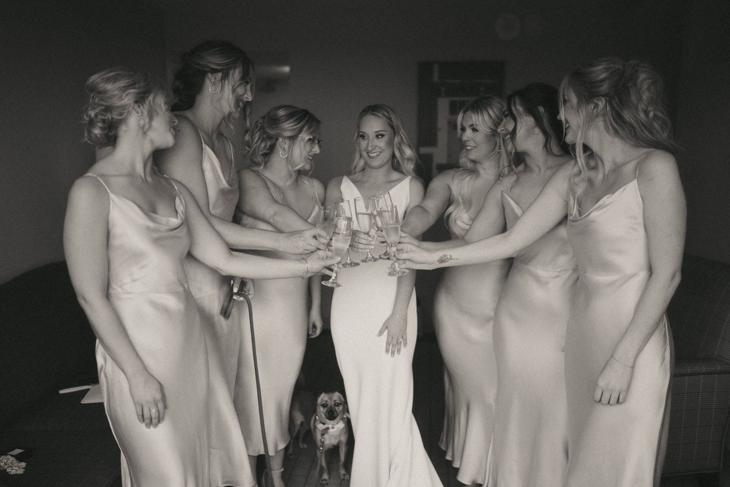 A group photo showing bridesmaids in matching dresses at a wedding celebration.