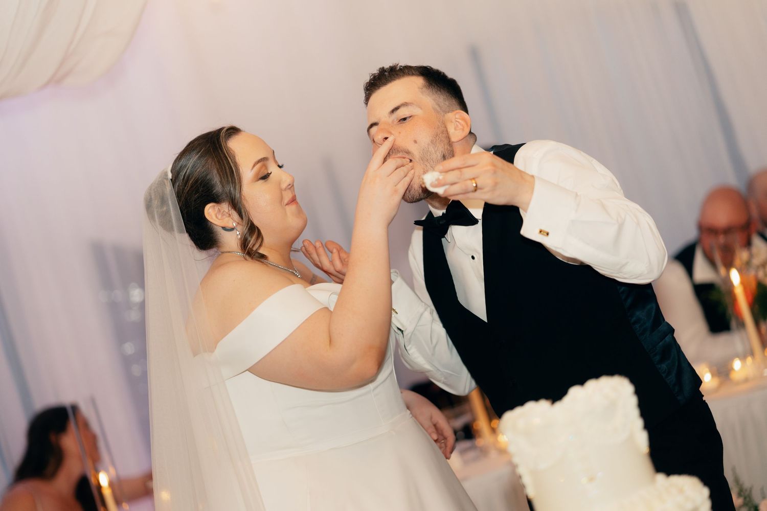 Newlyweds dance together in an elegant reception hall filled with joyful celebration.