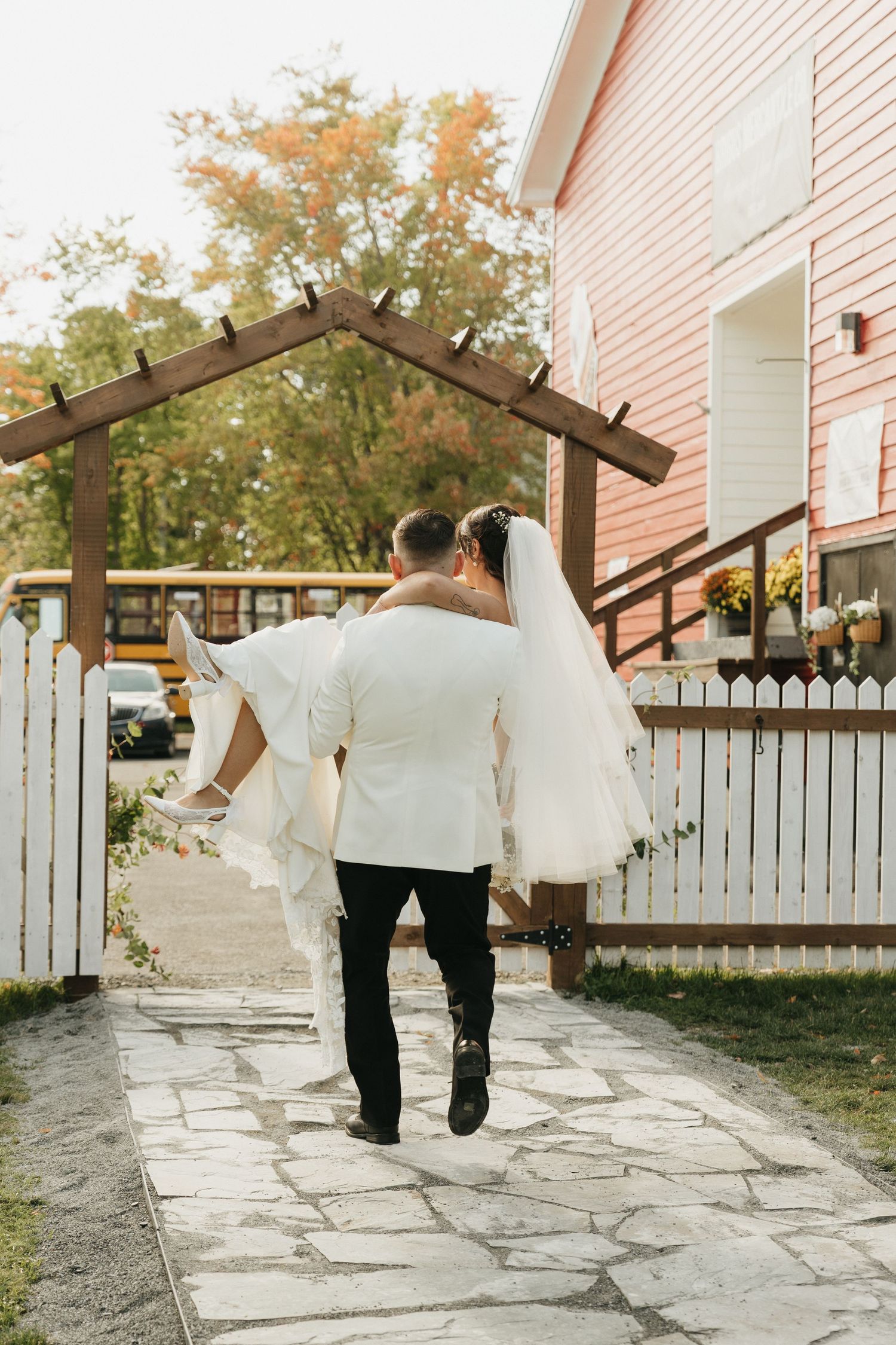 A sequence of photos showing a couple walking down a stone path with autumn trees and a white house in the background.