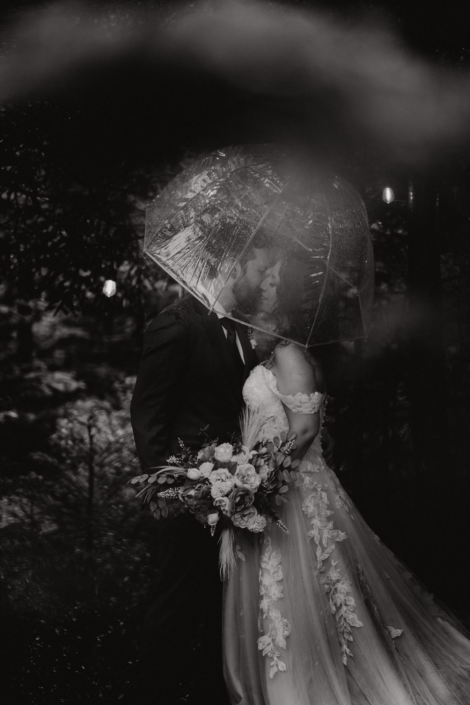 A romantic black and white wedding photo series showing tender moments between a couple in elegant wedding attire.