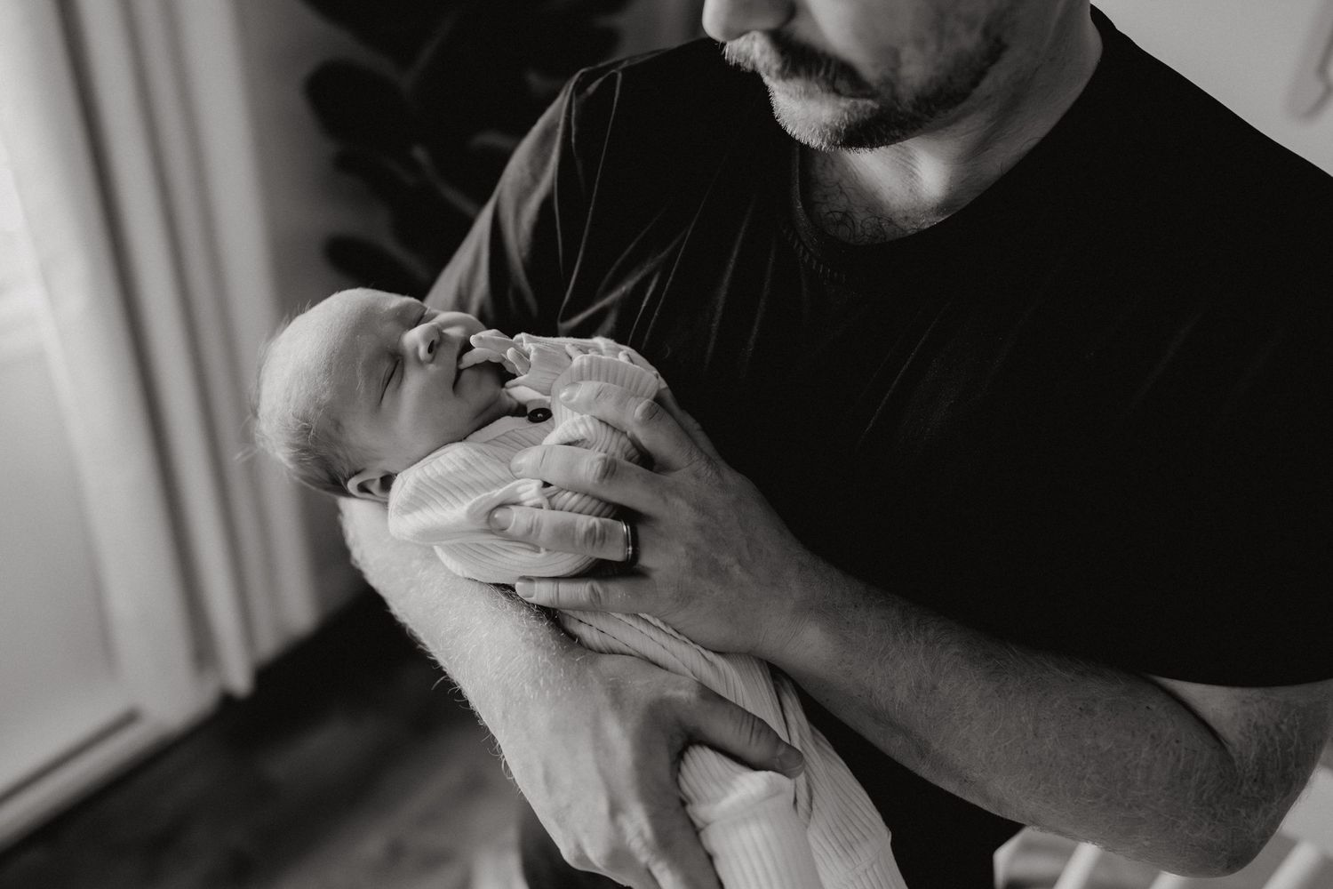 Intimate black and white portraits capturing quiet moments with a small baby.