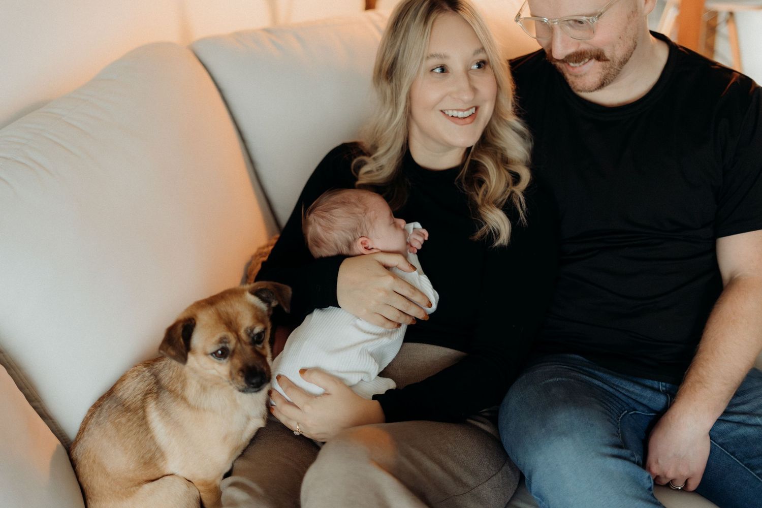 Intimate home photography session showing family bonding with their pet dog.