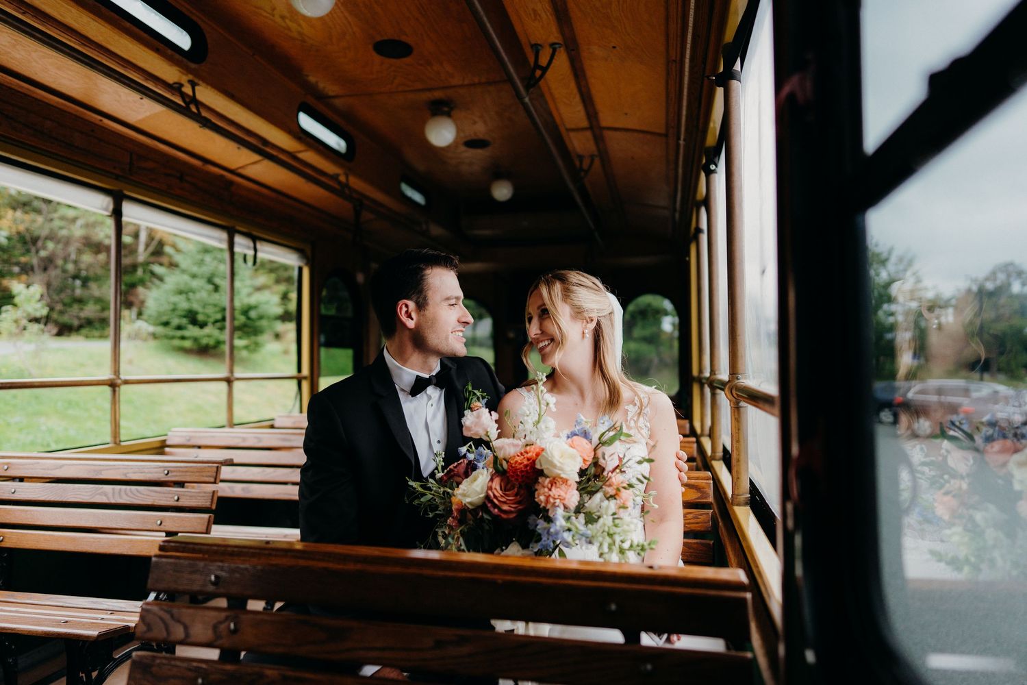 Interior shots of a vintage trolley or bus with wooden benches.