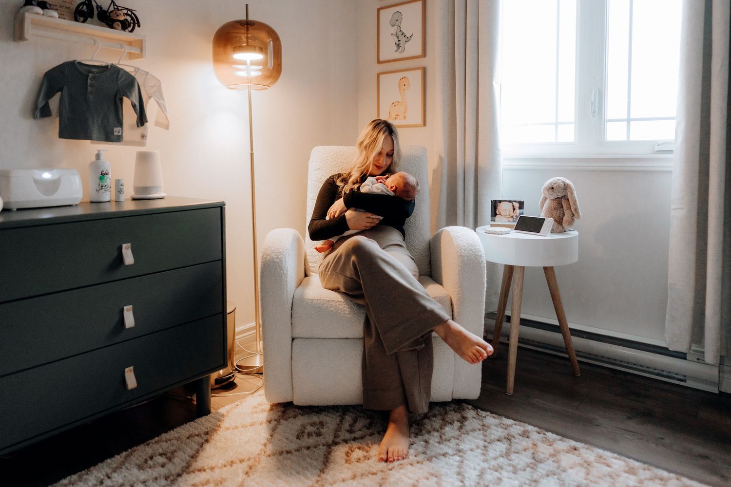 Stylish nursery space with pendant lighting and monochromatic decor.