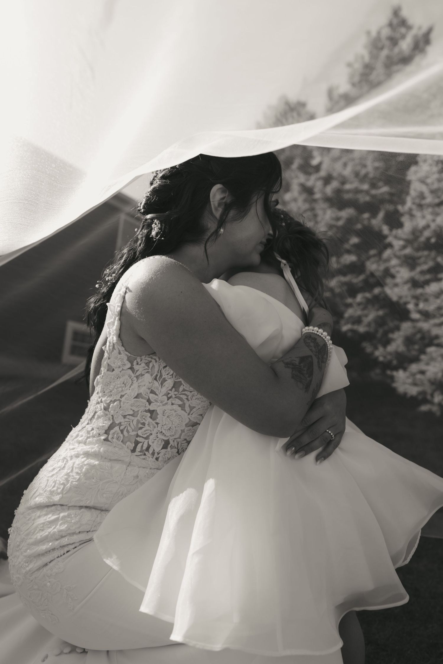 A romantic black and white photo sequence showing a couple in wedding attire sharing an intimate dance moment outdoors.