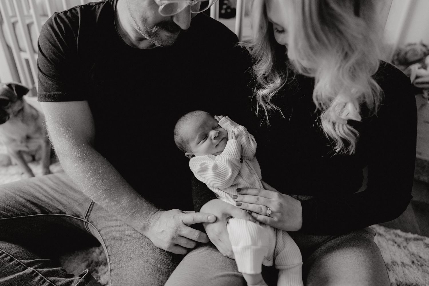 Tender moment captured of a small infant being cradled in a home setting.
