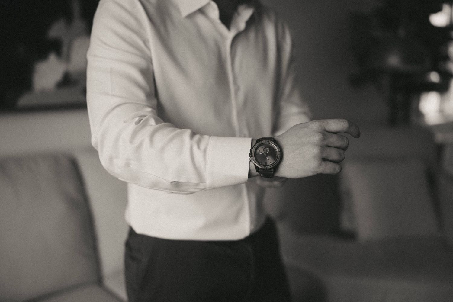Close-up shot of someone wearing a white button-down shirt and dark suit.