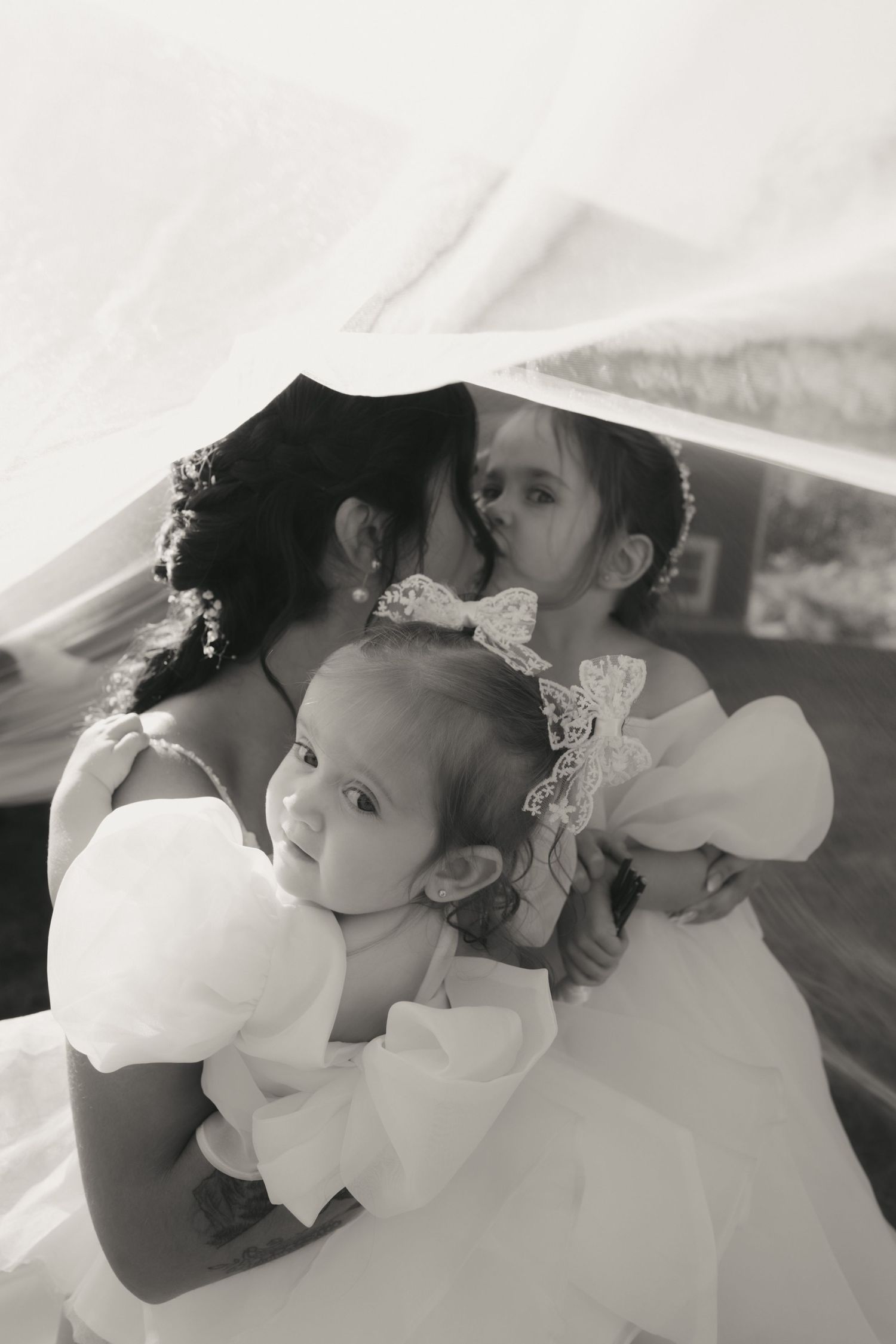 A romantic black and white photo series showing tender moments between a couple on their wedding day.