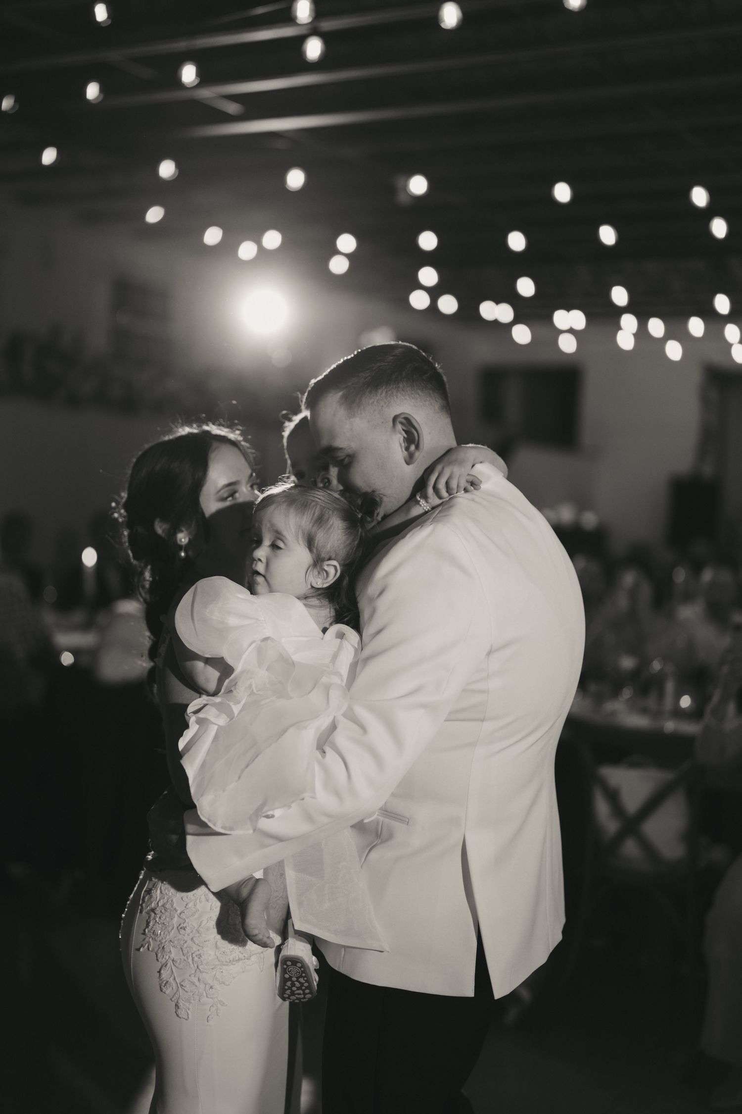 A romantic black and white photo sequence shows a couple sharing their first dance at a wedding reception.
