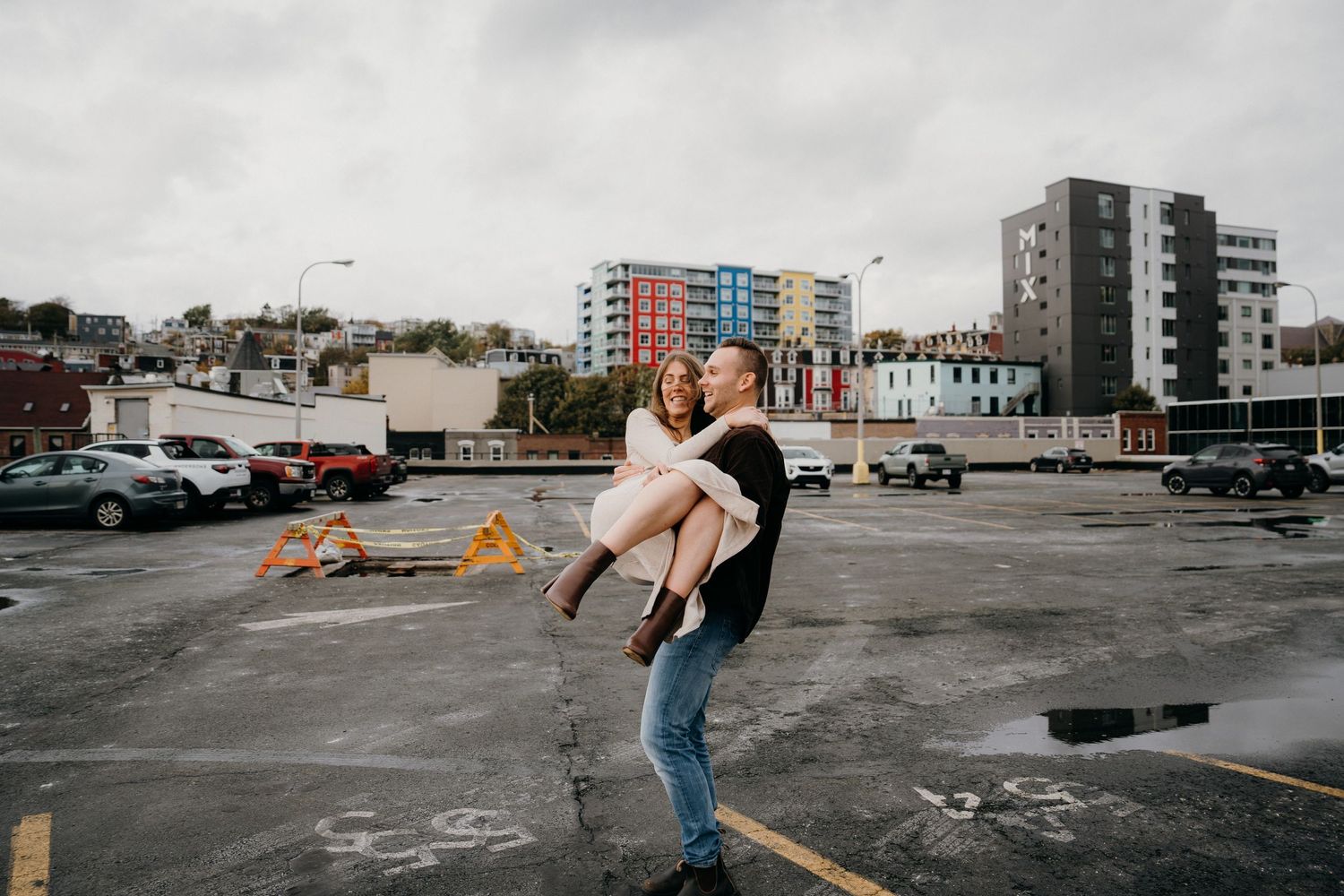 Contemporary dance sequence photographed in a stark urban environment with modern buildings.