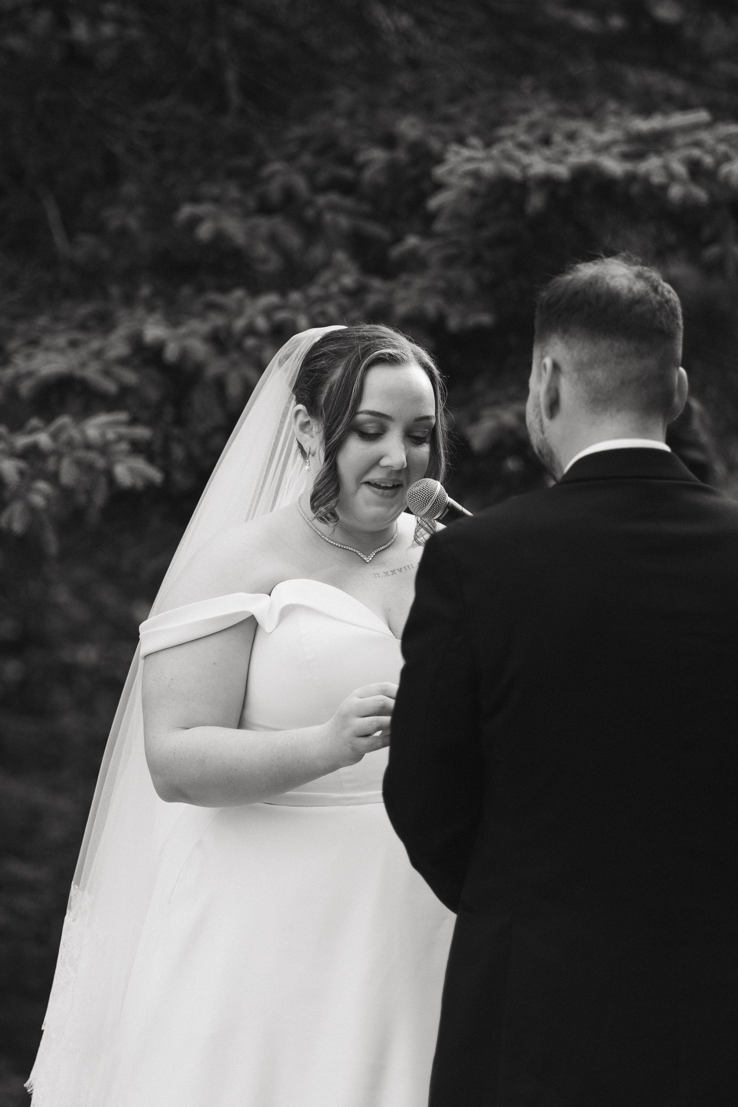 Black and white emotional moments during wedding vow exchange.