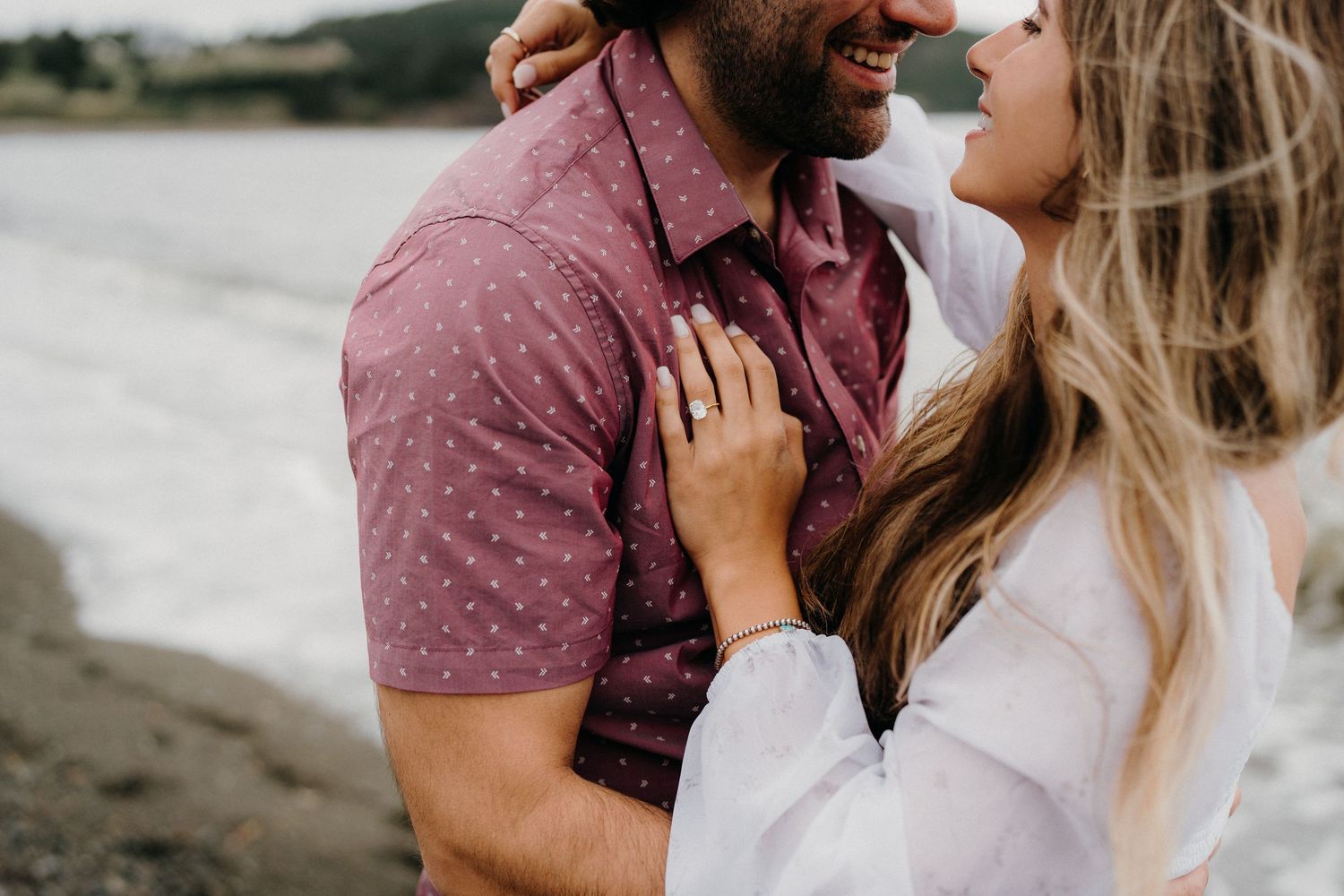 Close up of a couple sharing an intimate moment against a bright white background.